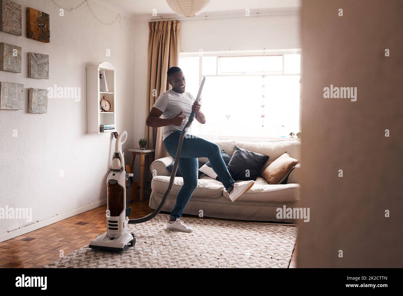 The vacuum is my favorite instrument. Shot of a young man dancing while