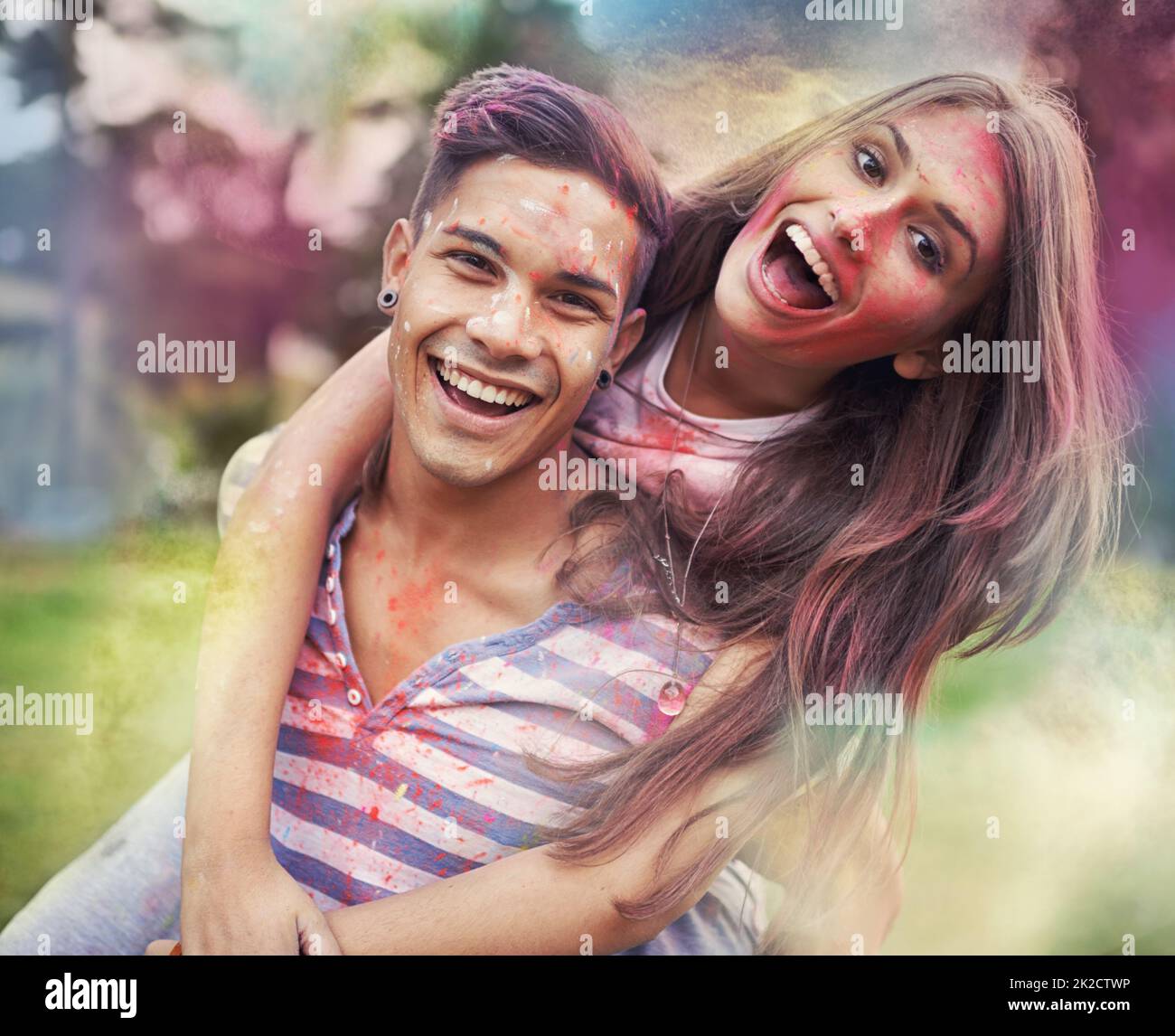 Happiness in color. Shot of happy friends having fun with powder paint