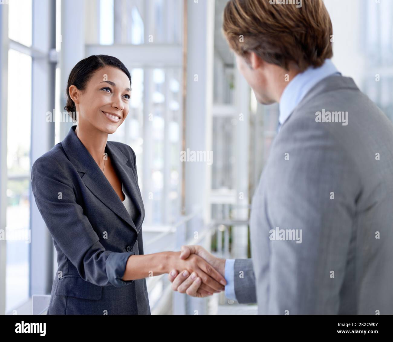 Working their way to the top. Shot of two professional colleagues in an office building. Stock Photo