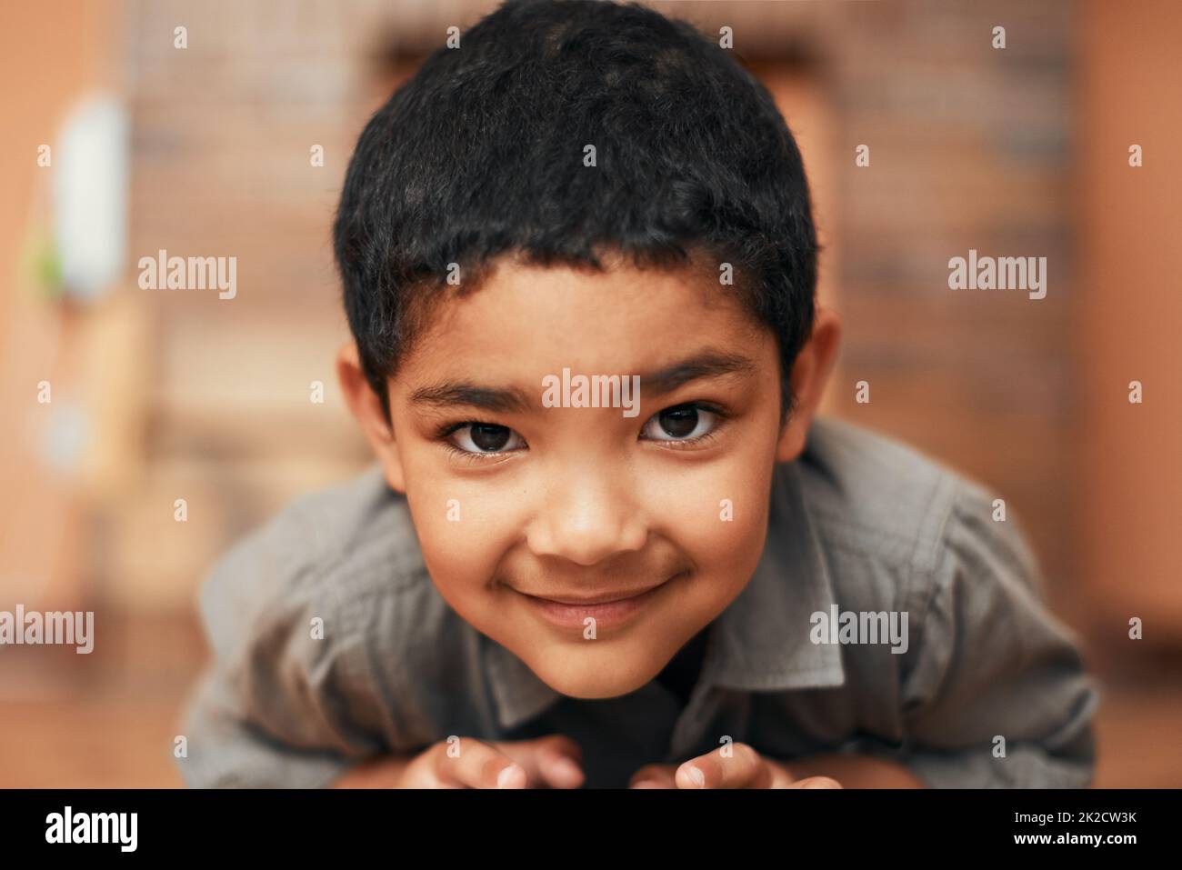 Showing off his collection of cars. Portrait of an adorable little boy playing with toy cars at home. Stock Photo