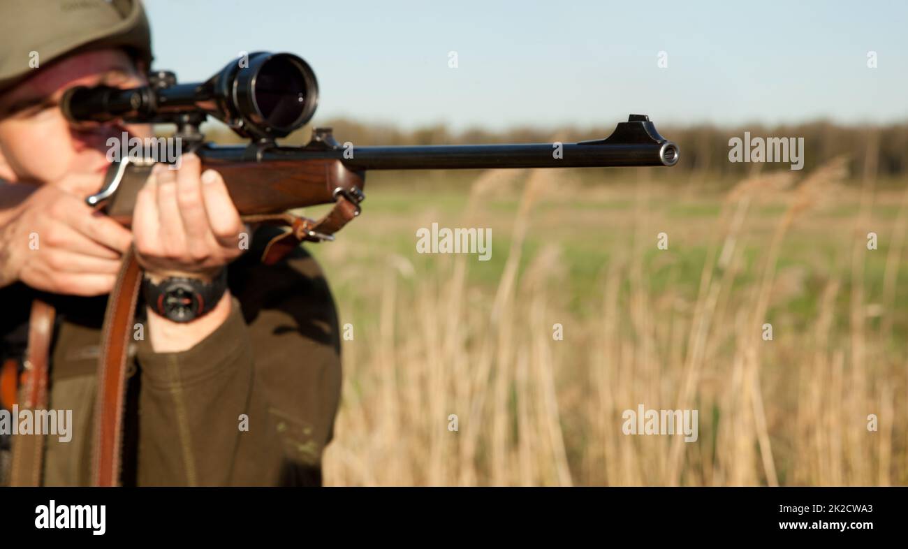 Taking aim. Cropped shot of a man hunting in the wild. Stock Photo
