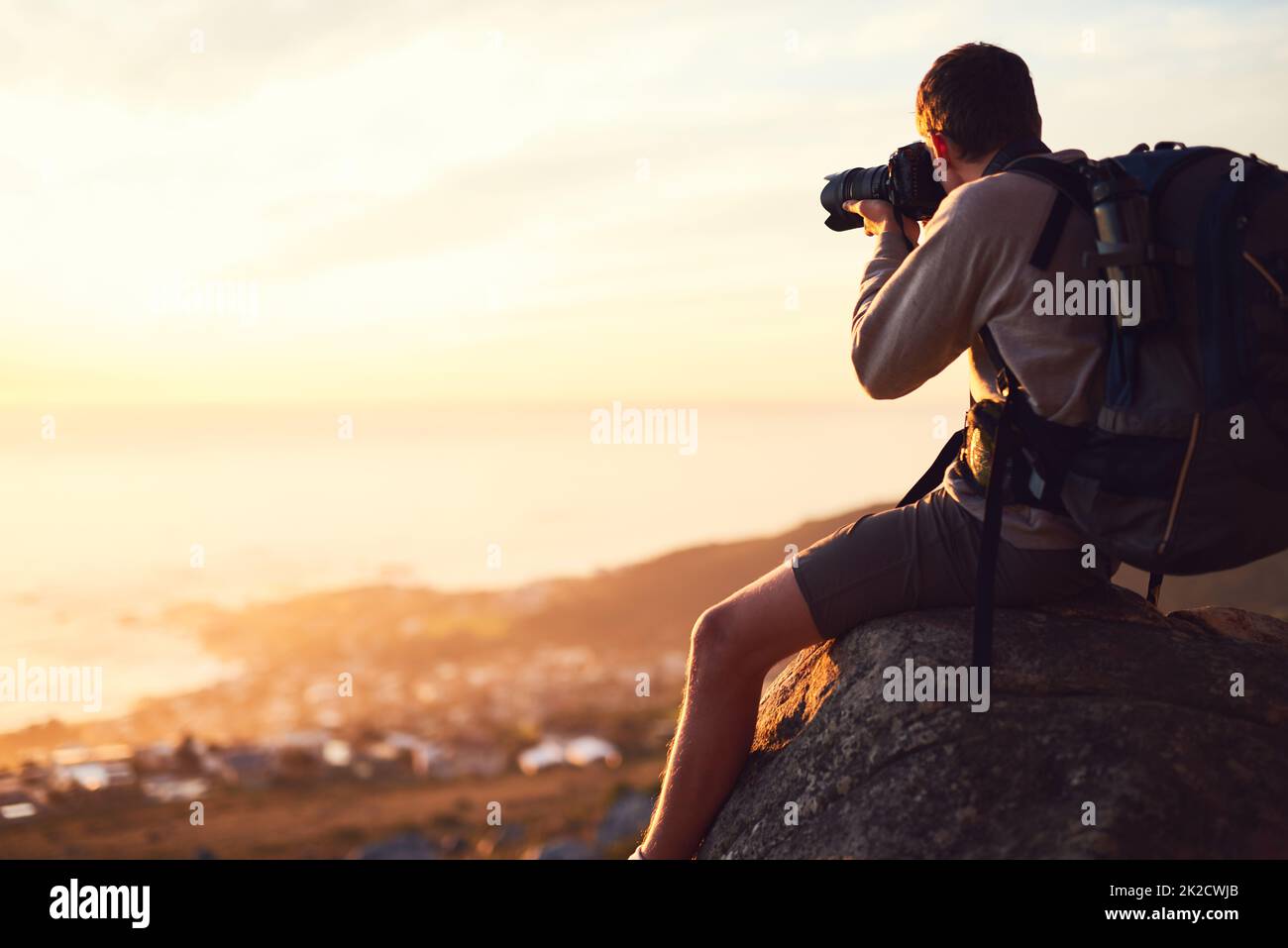 Hike more, worry less. Shot of a young photographer taking a picture from the top of a mountain. Stock Photo