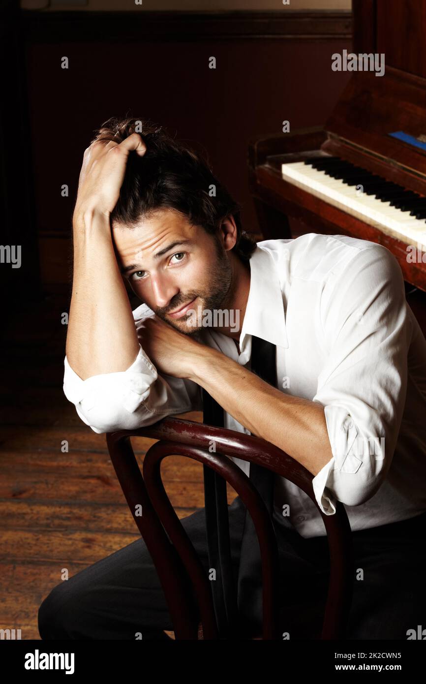 Moody musician. Portrait of a young musician sitting in front of his