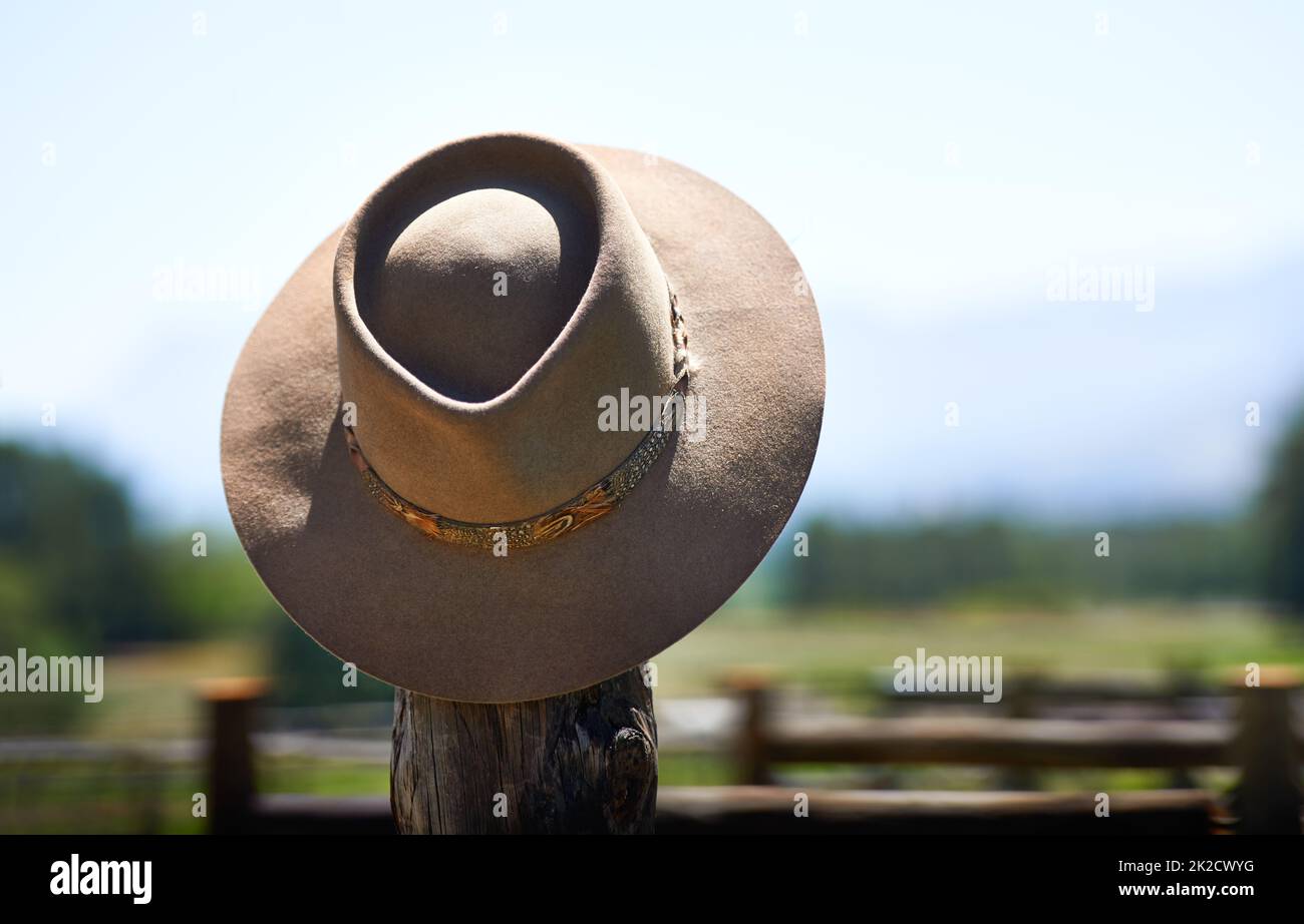 Hats off to you. Shot of a wide brimmed hat on a fence post. Stock Photo