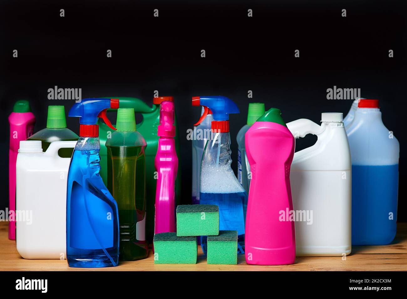 Cleaning equipment. Shot of various bottles of detergents isolated on black. Stock Photo