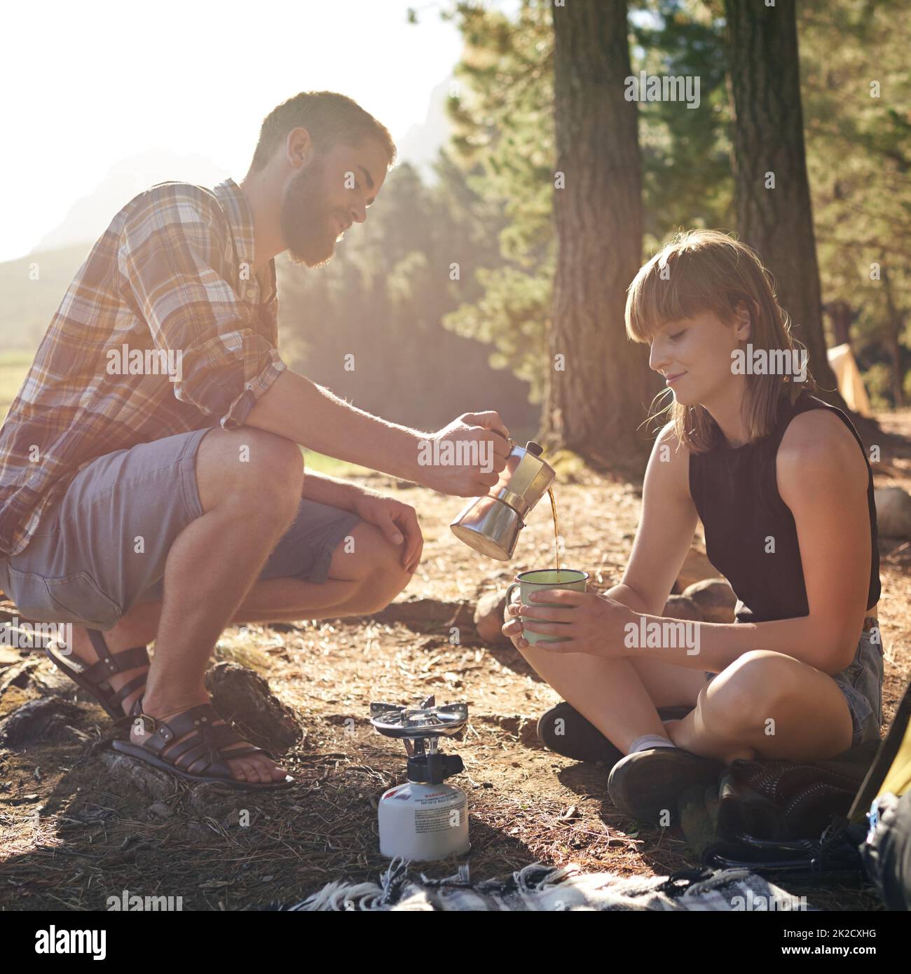 Morning coffee on the brew. Shot of a young couple making coffee on a