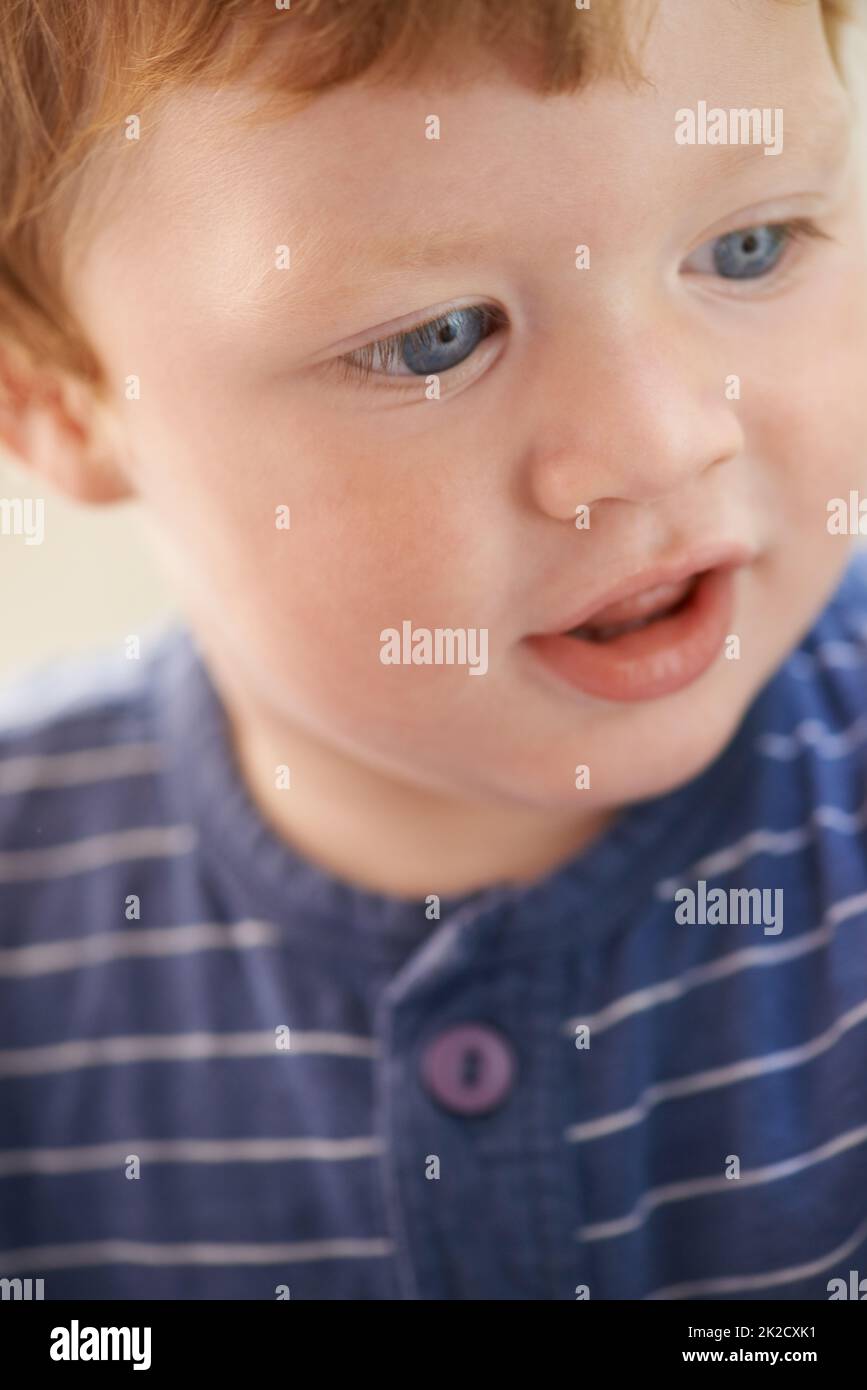 Filled with innocence. Cropped view of a cute red-headed toddler. Stock Photo