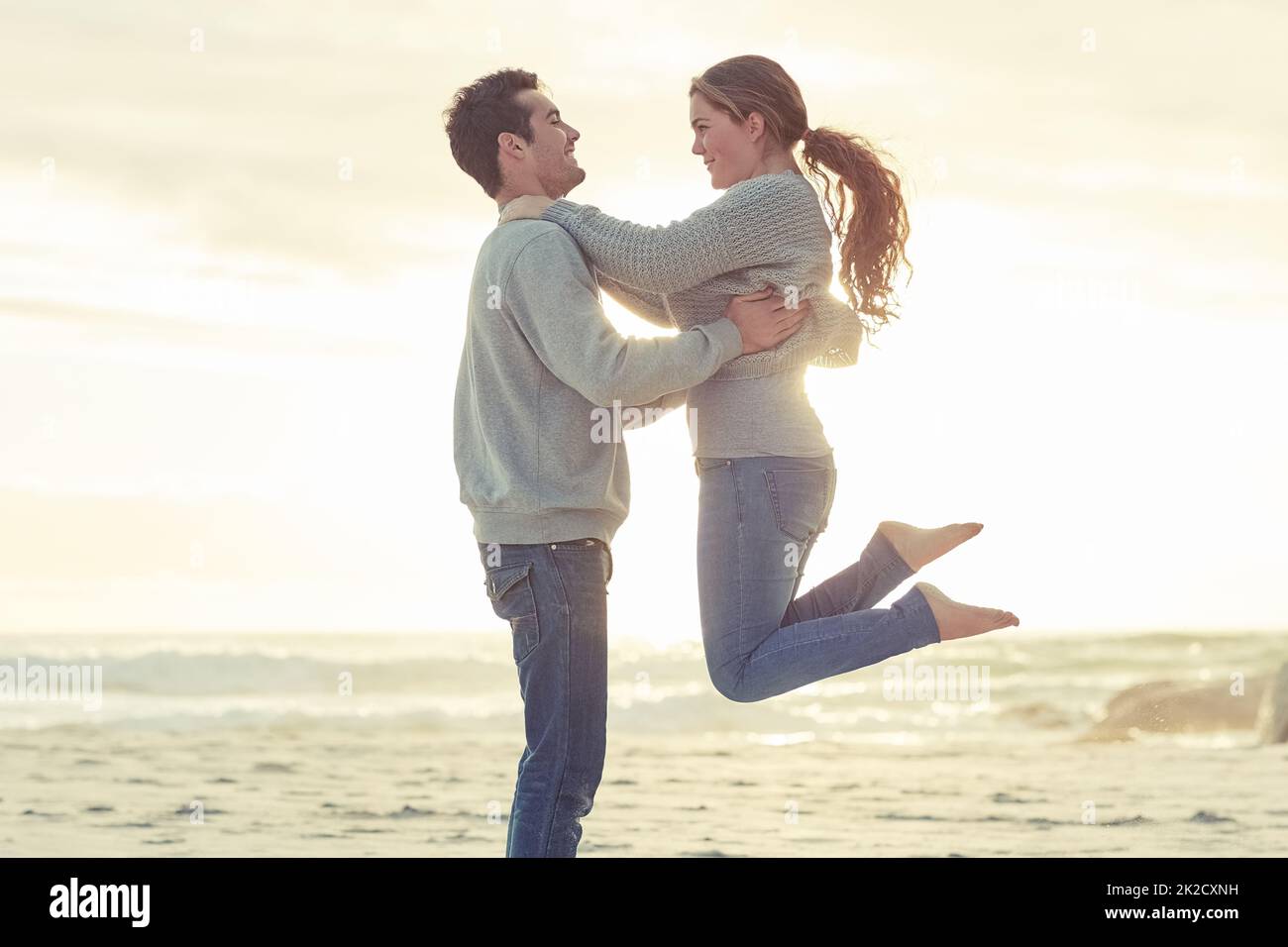 Seaside romance. Shot of a young couple relaxing on the beach together on the weekend. Stock Photo
