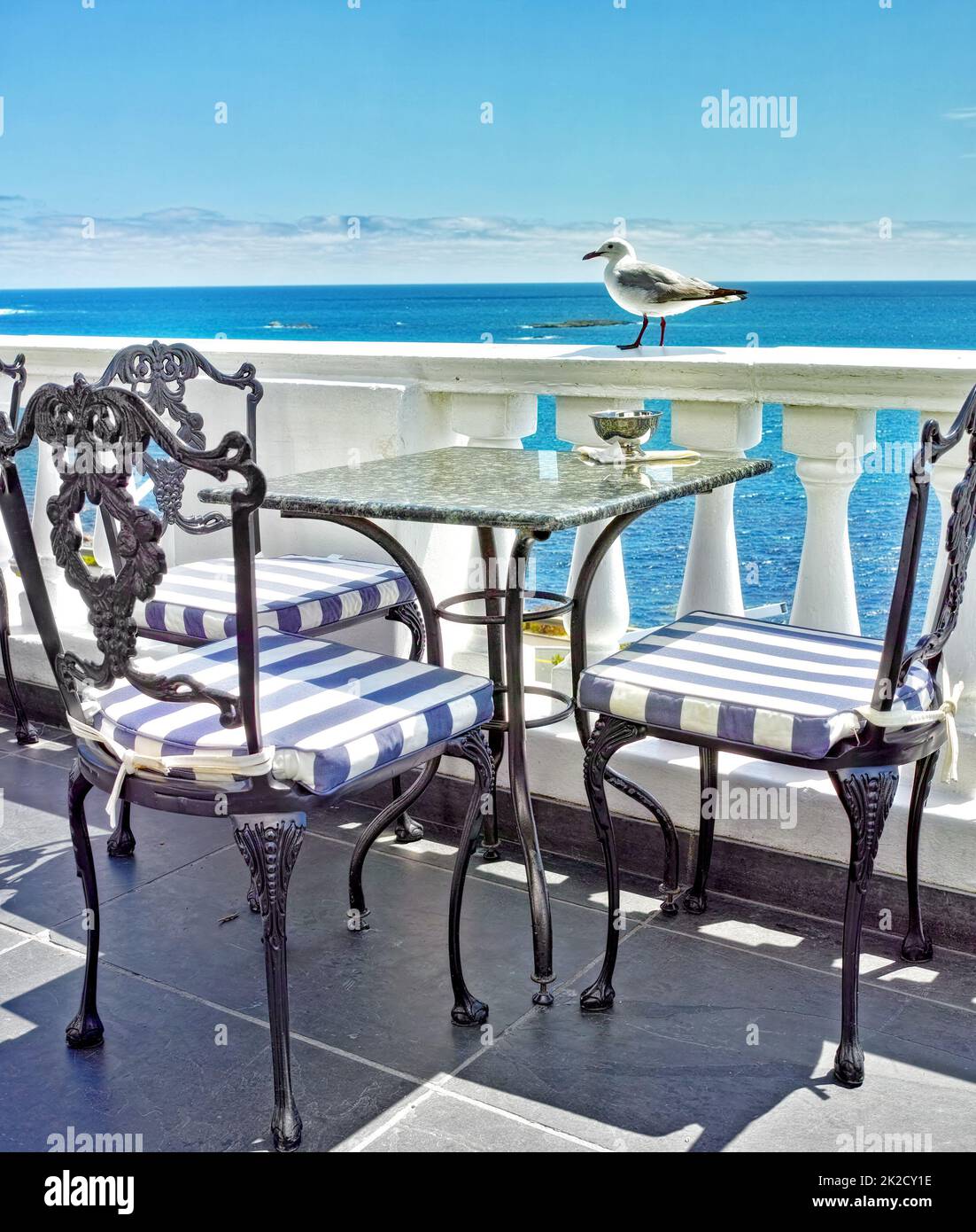 Vacation at the shore. Tables and chairs on the balcony of a seaside