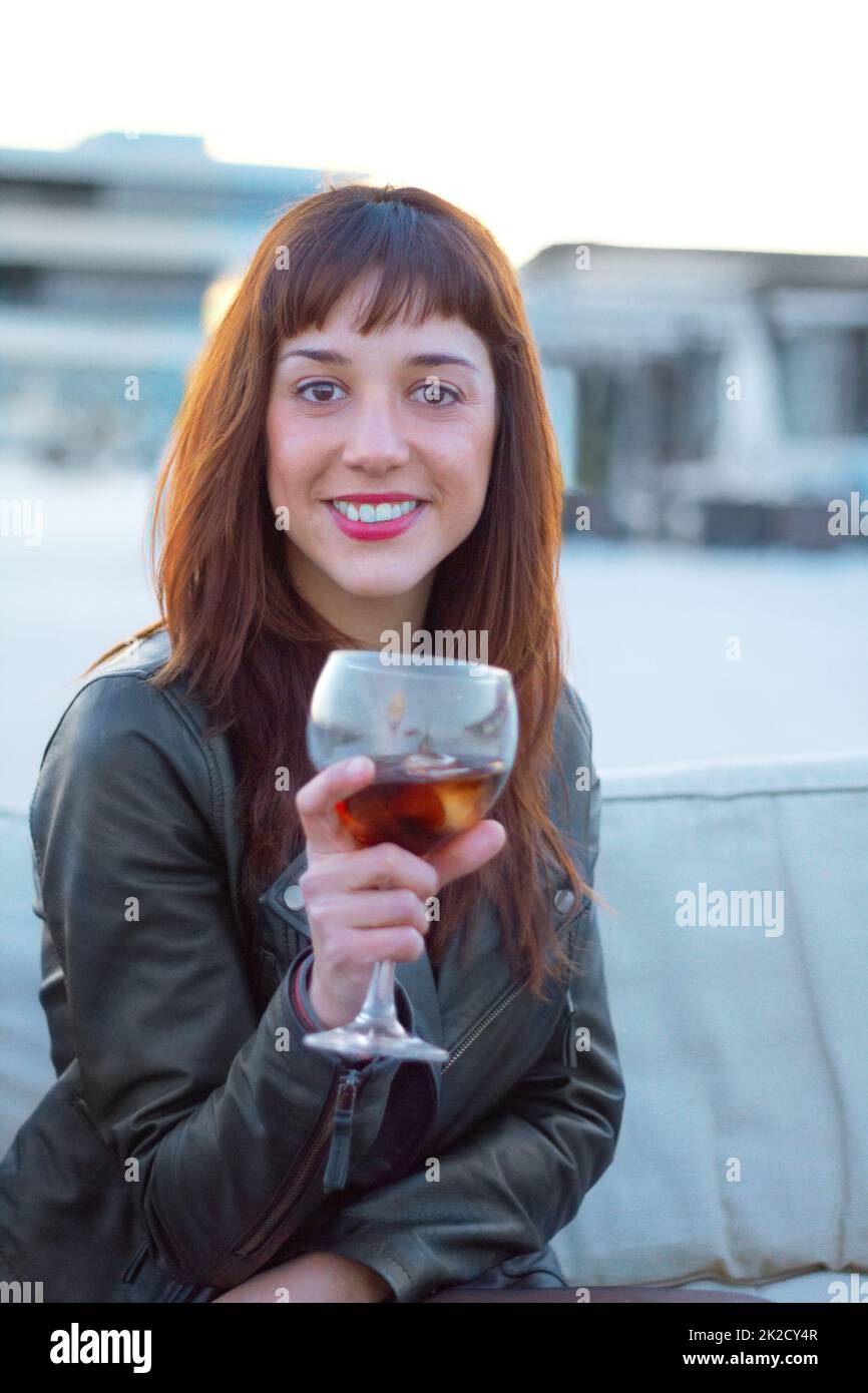 Time to live a little. Shot of a beautiful woman holding an alcoholic beverage. Stock Photo