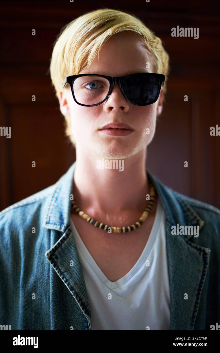 Seeing one point of view. Attractive young guy wearing hipster glasses with one side blacked out Stock Photo Alamy