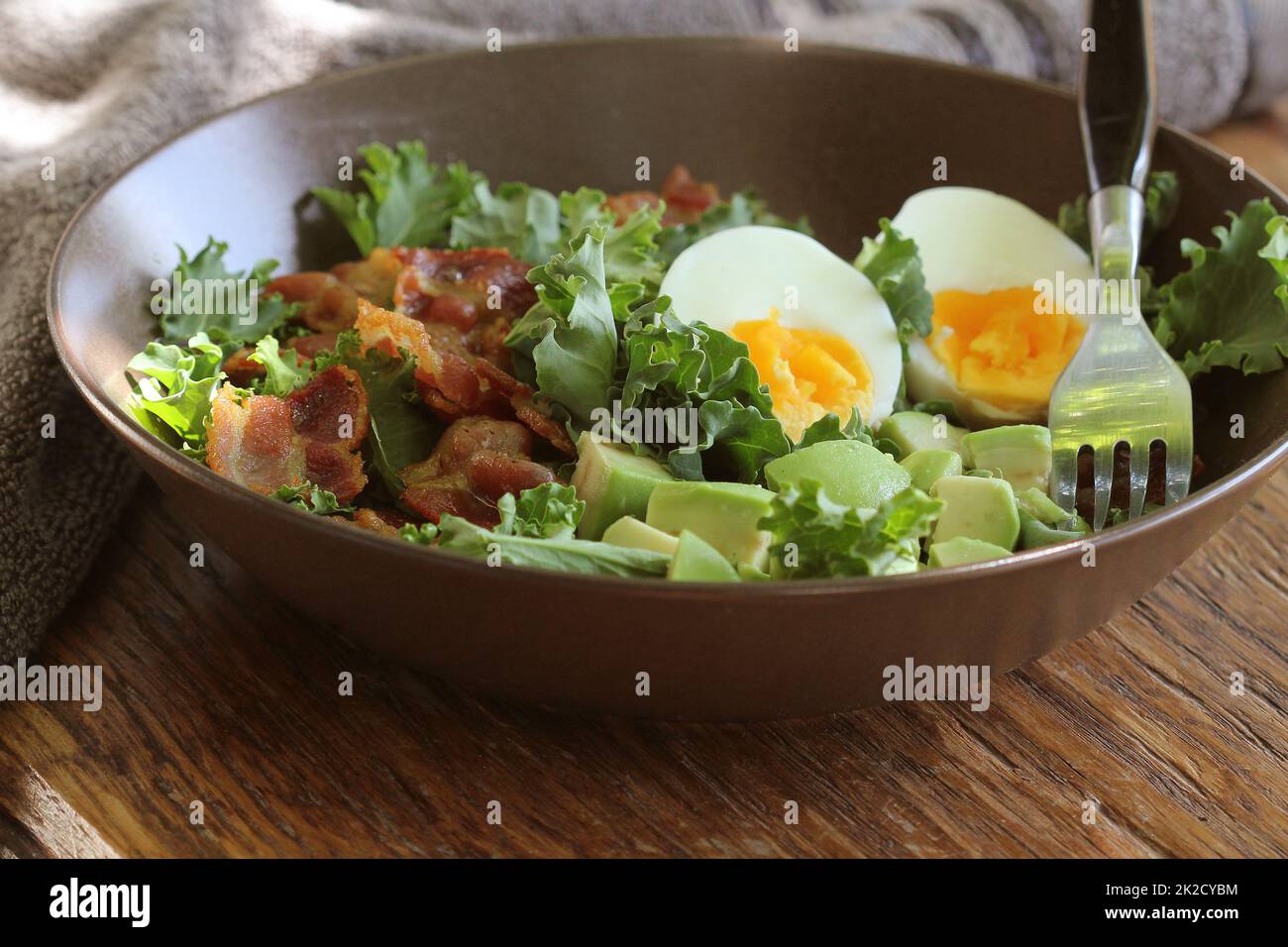 Vegan salad with kale,avocado, crispy bacon, egg and Vinaigrette