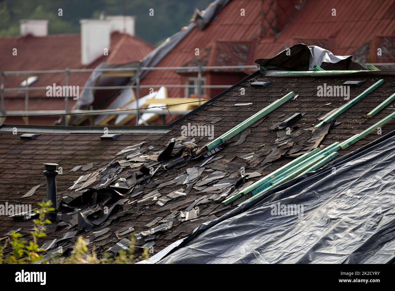 Storm damaged roof, destroyed roof tiles, expensive damage needing prompt repair Stock Photo