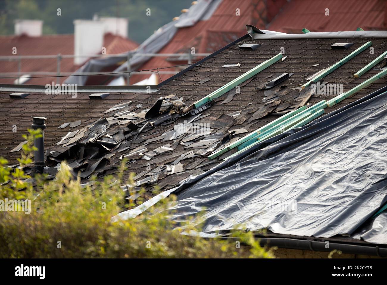 Storm damaged roof, destroyed roof tiles, expensive damage needing prompt repair Stock Photo