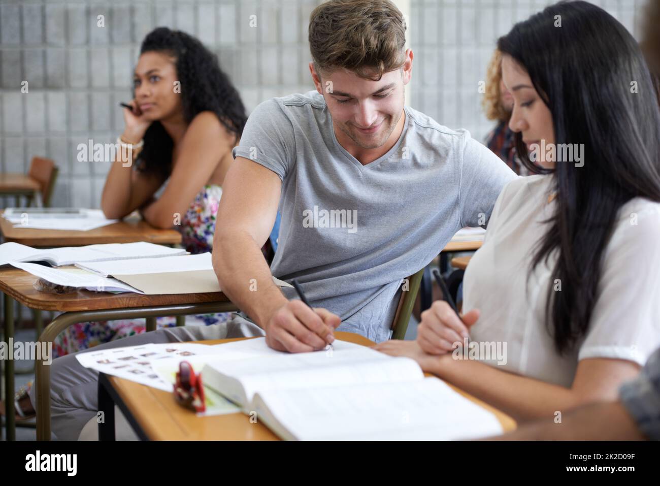 Aiming for an A. Shot of young college students studying in class. Stock Photo