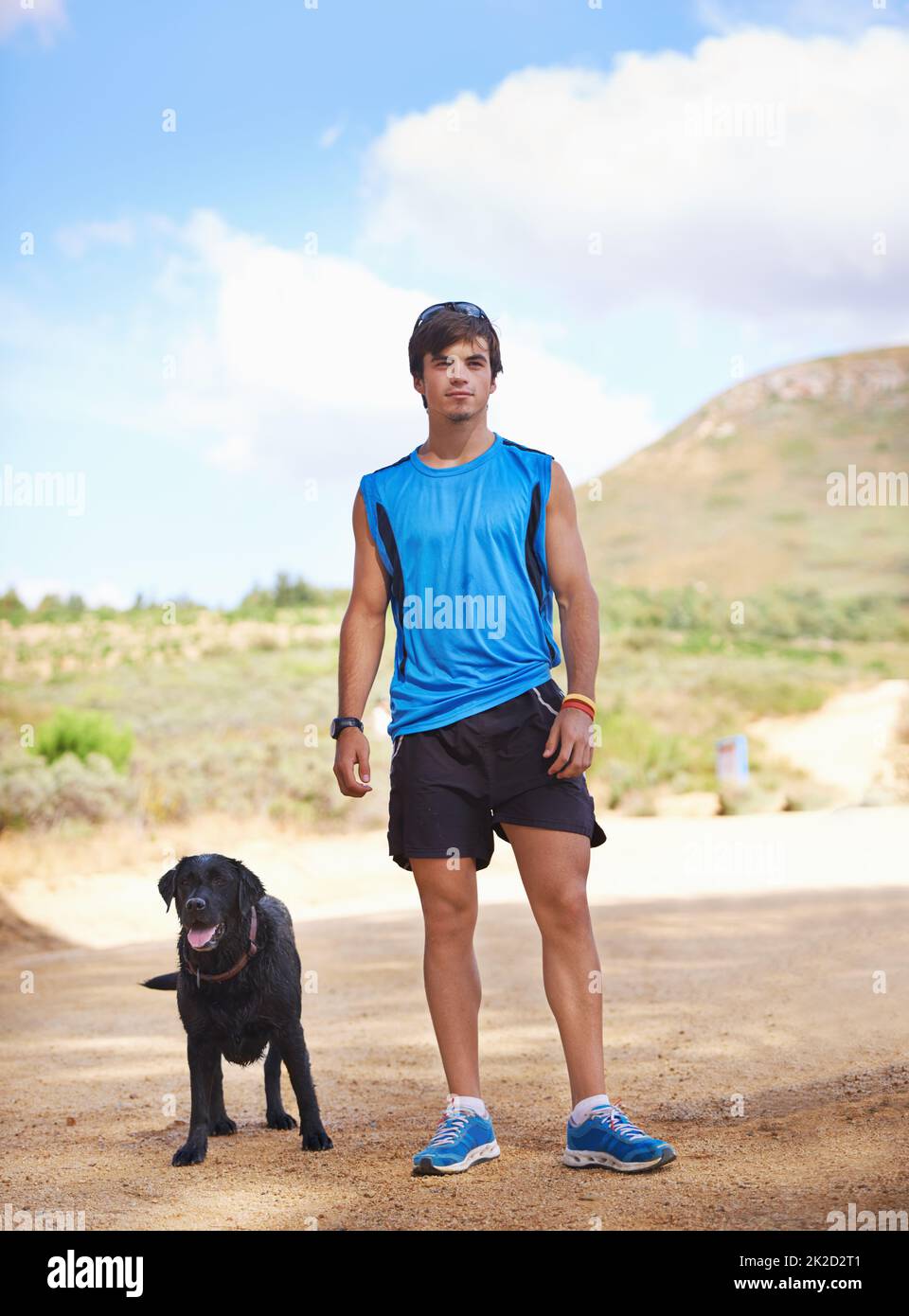 Theres nothing like fresh air and exercise. Shot of a young man exercising outdoors with his dog. Stock Photo