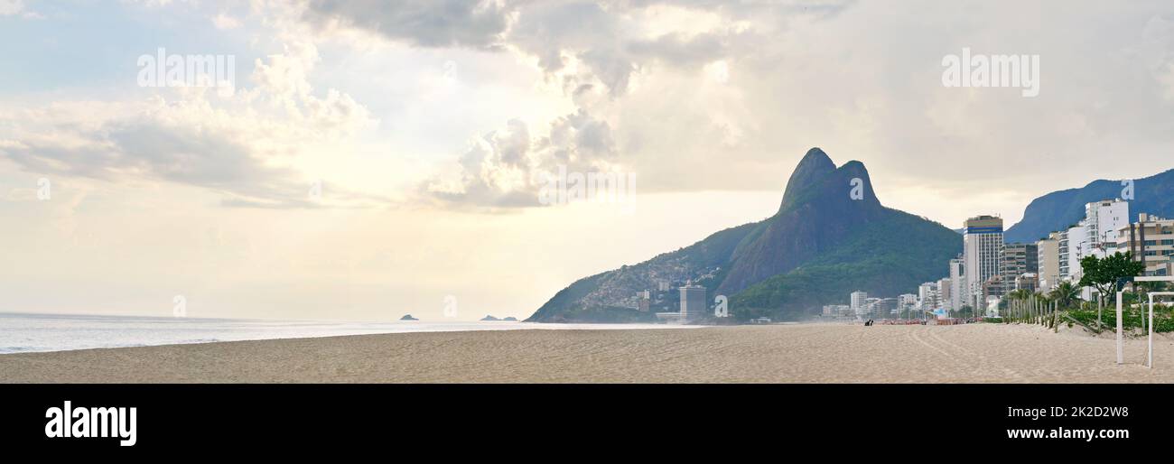 Sunset over paradise. Shot of a rio beach with the sun setting. Stock Photo