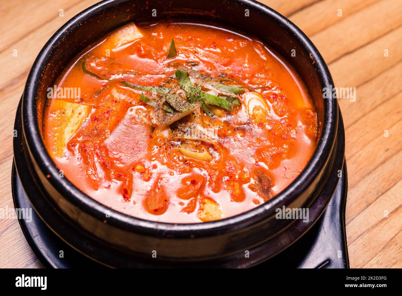 Korean traditional Kimchi Jjigae soup in bowl in the restaurant Stock