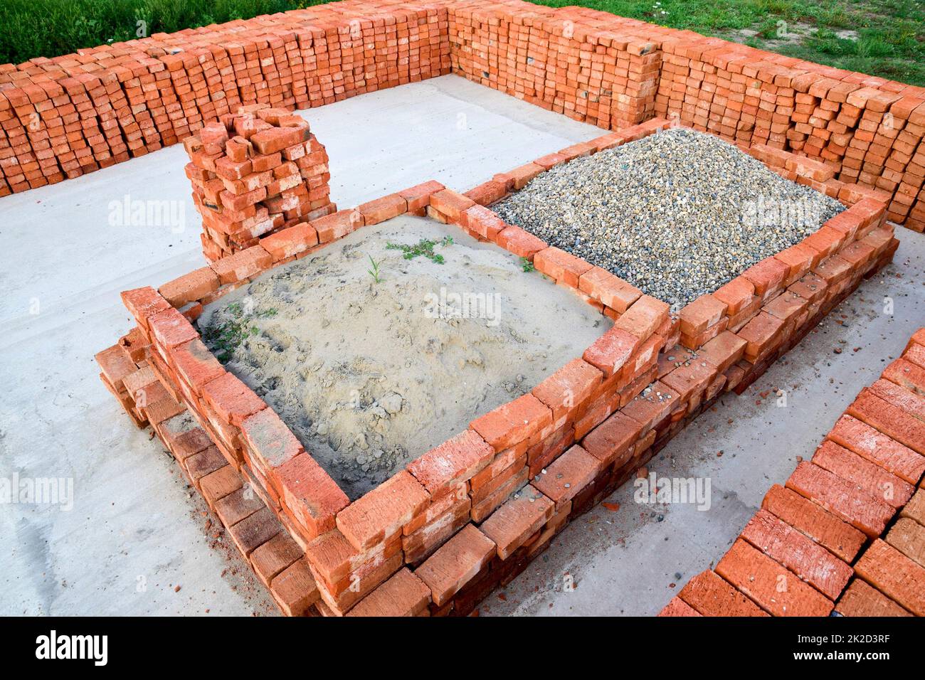 The red brick folded neatly on the foundation of the house. Home construction Stock Photo