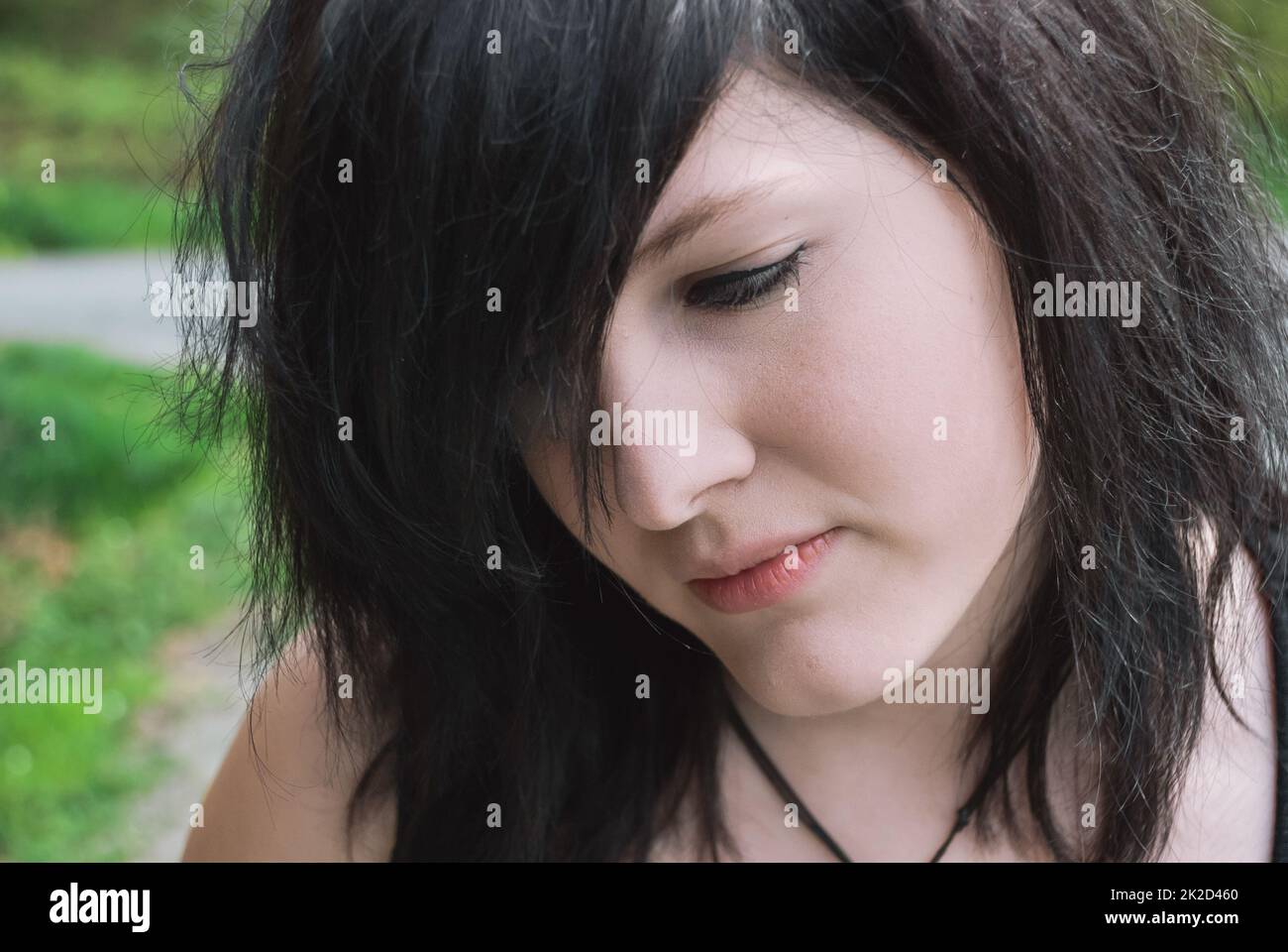 Gothic emo girl looking down, close-up Stock Photo