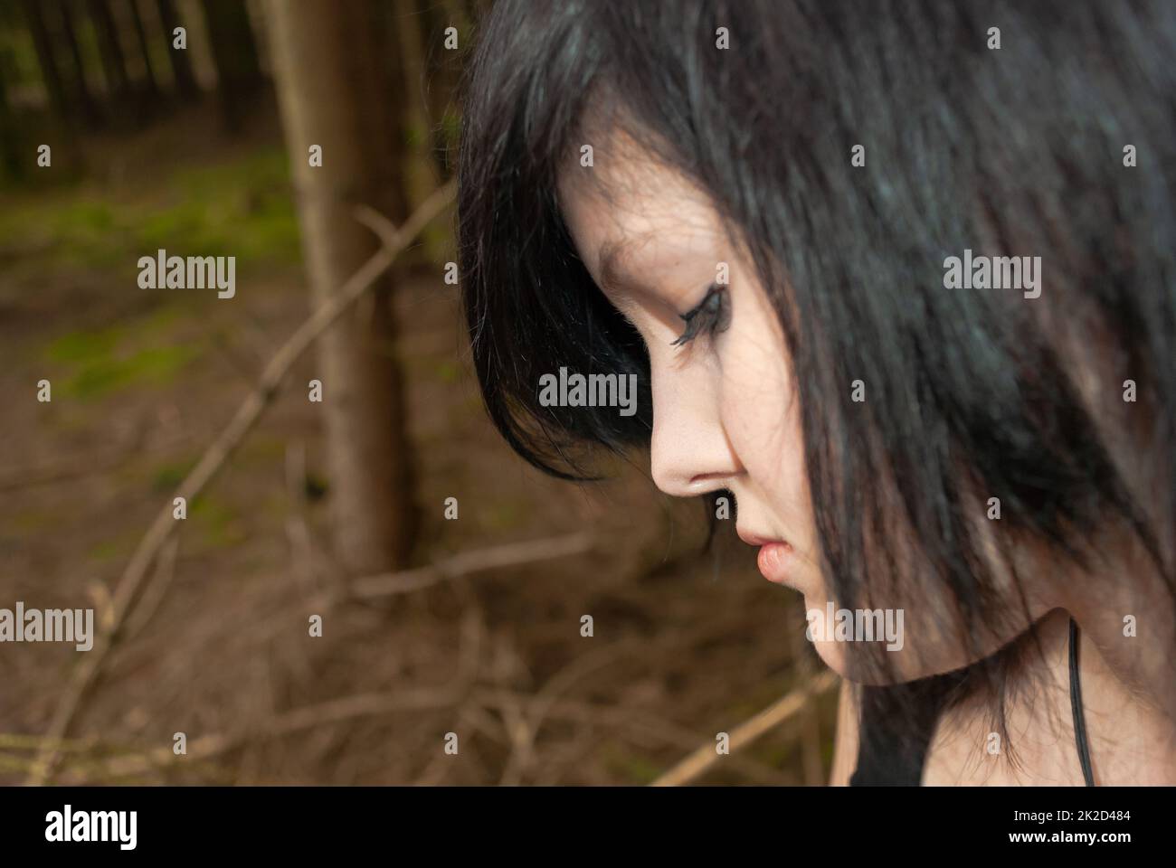 Punk emo girl, young adult with black hair and eyeliner, close-up Stock Photo