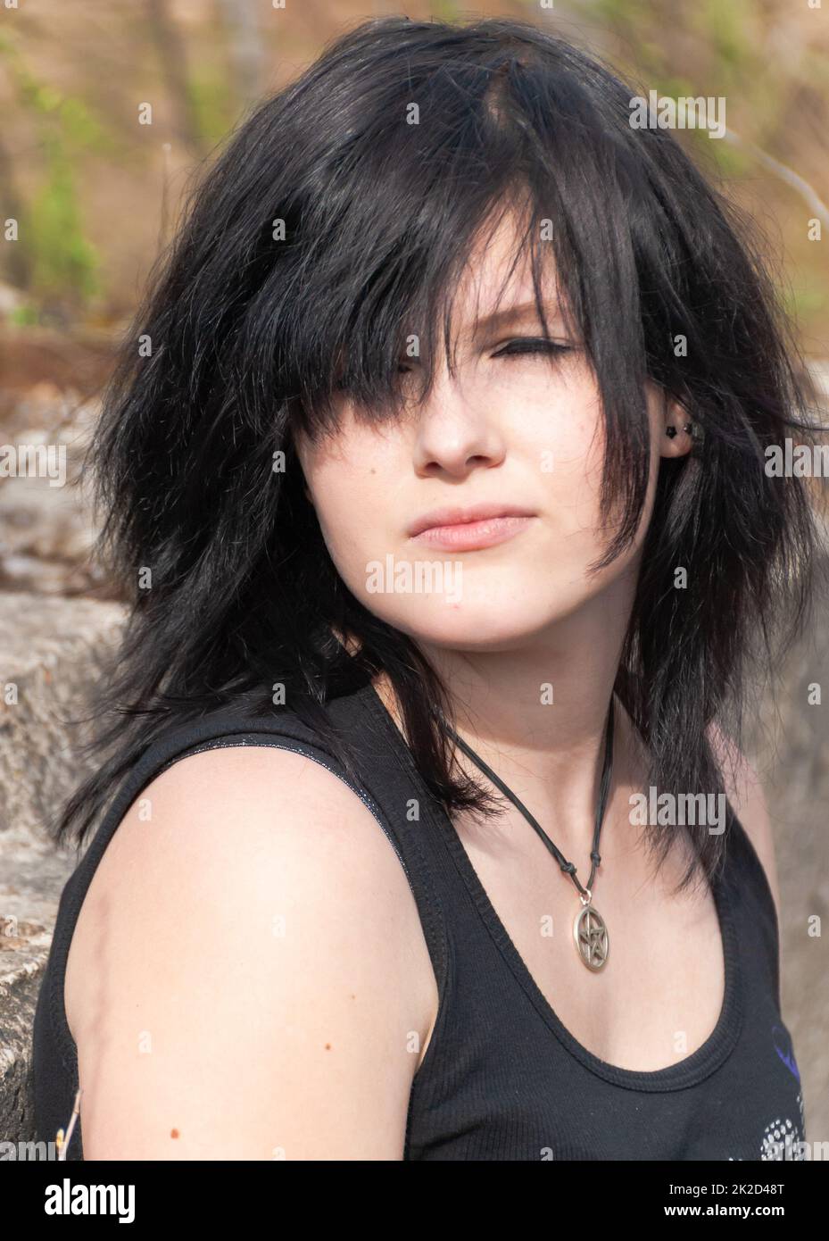 Punk emo girl, young adult with black hair and eyeliner, close-up Stock Photo