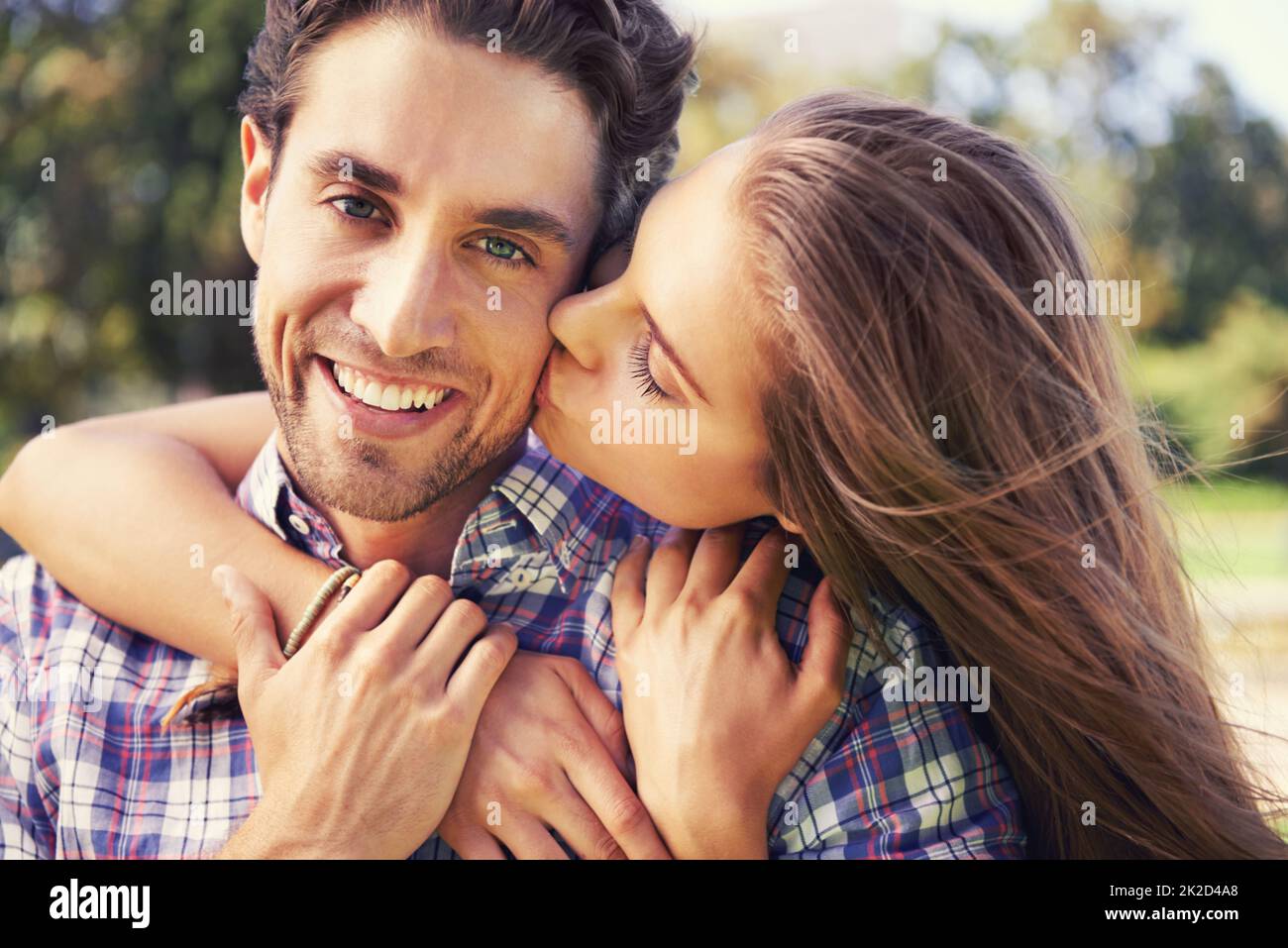 Big kiss for my man. Closeup portrait of a young couple sharing a