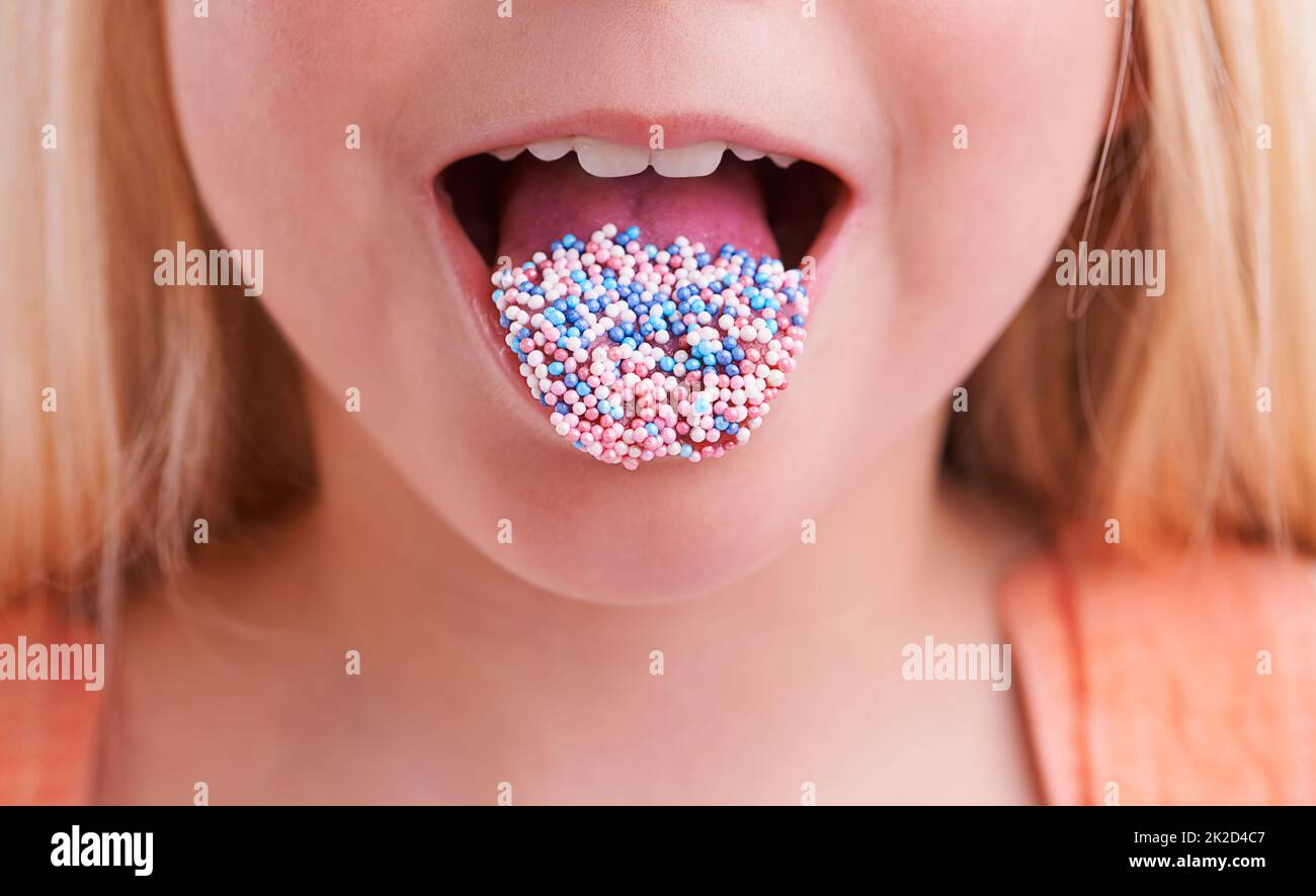 Mmmm, delicious. Cropped closeup of a little girl with candy on her