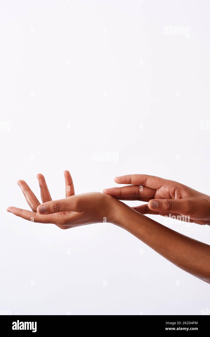 Keep them feeling soft. Studio shot of an unrecognizable womans hands against a white background. Stock Photo