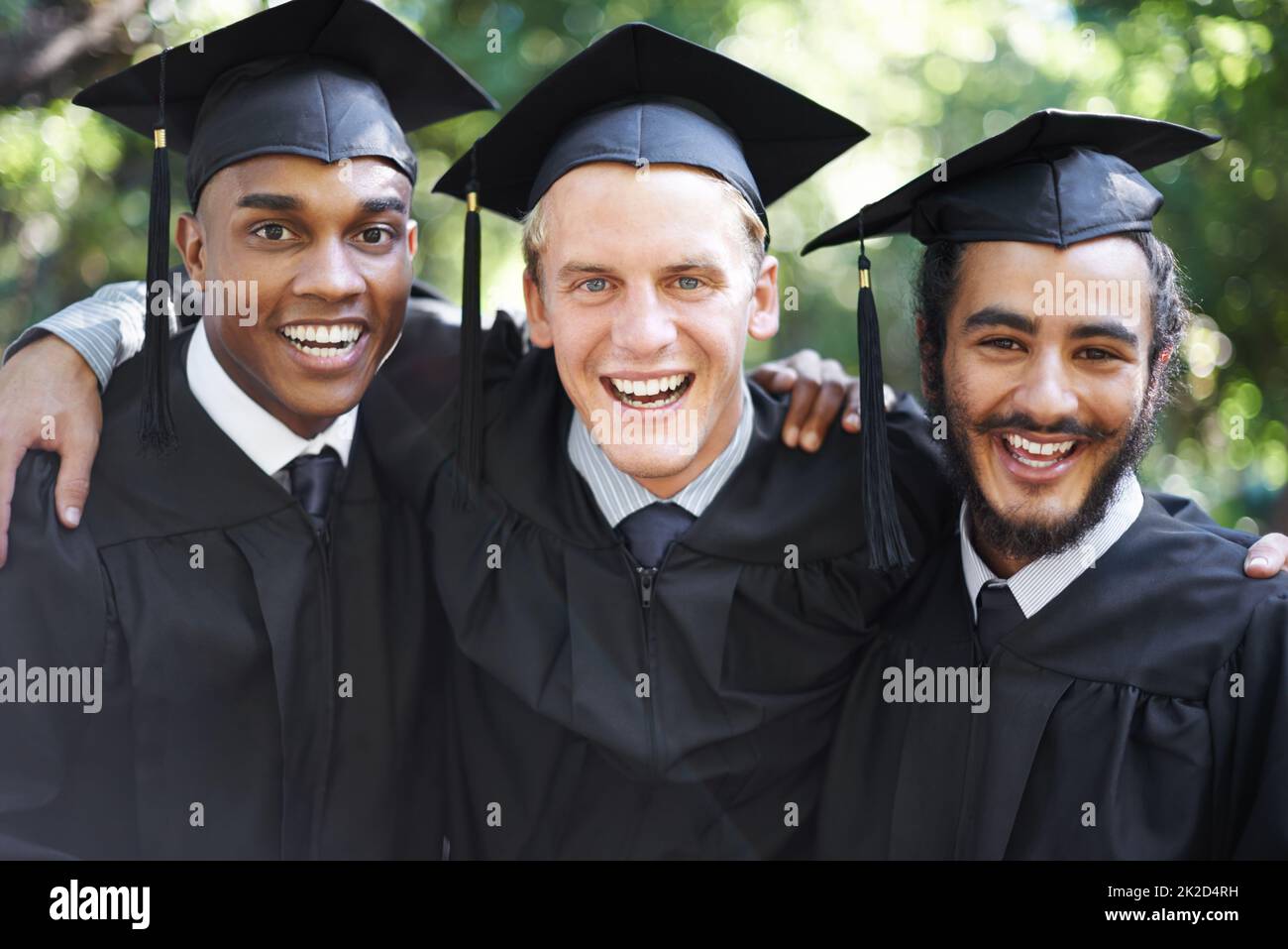 Its been tough, but weve finally made it. A group of happy male students on graduation day. Stock Photo