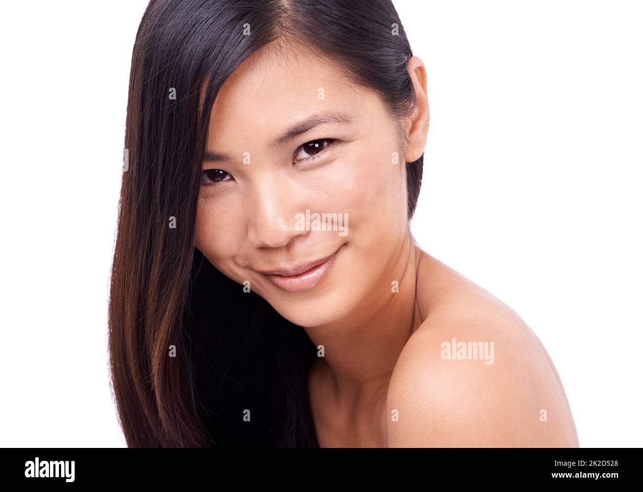 Charm and innocence. Cropped shot of a beautiful young oriental woman against a white background. Stock Photo