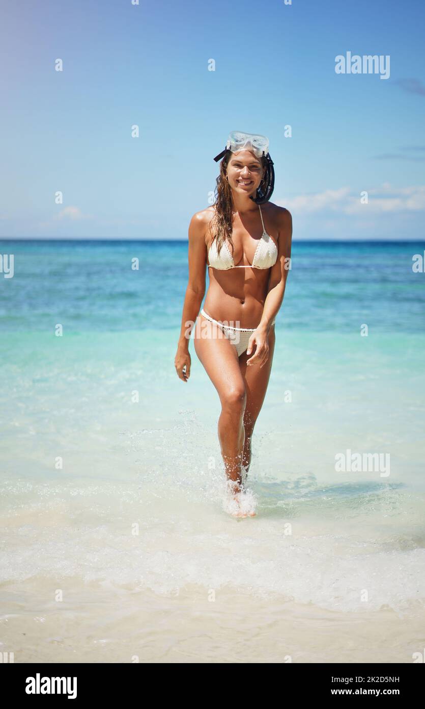 Teenage Girl Holding Beach Ball At Beach Wearing Bikini High-Res