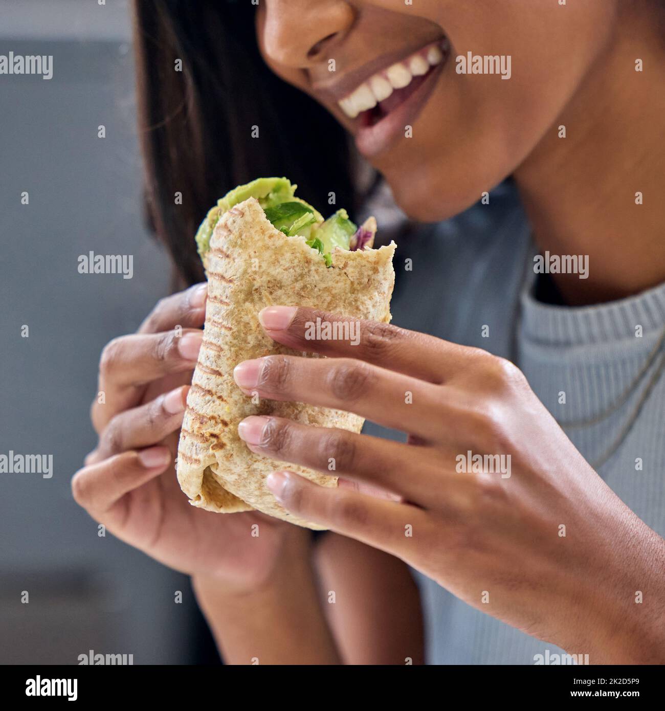 Woman eating wrap hi-res stock photography and images - Alamy