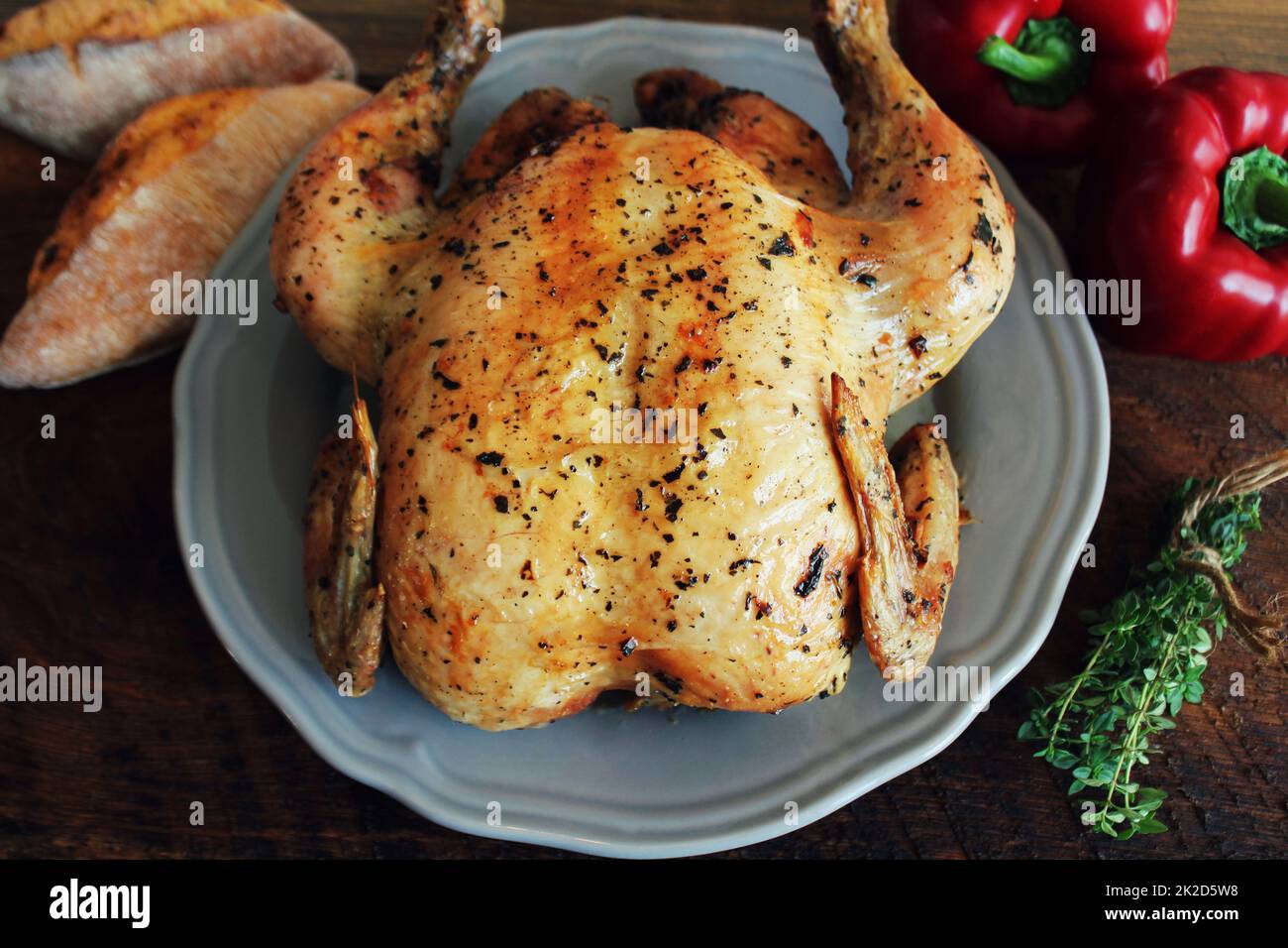 Whole roasted chicken on rustic table Stock Photo - Alamy
