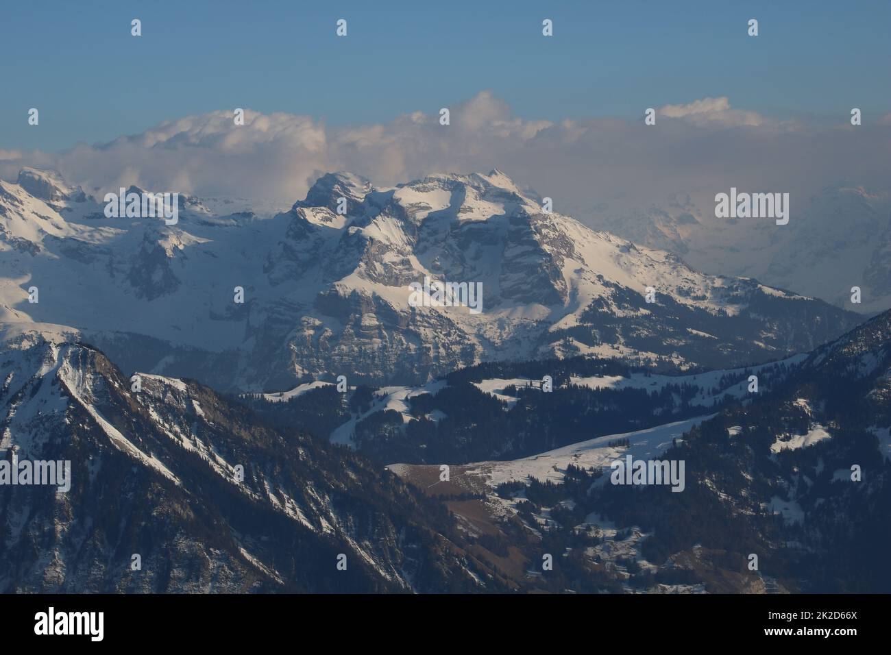 Snow covered peaks of the Swiss Alps on a cloudy morning Stock Photo ...