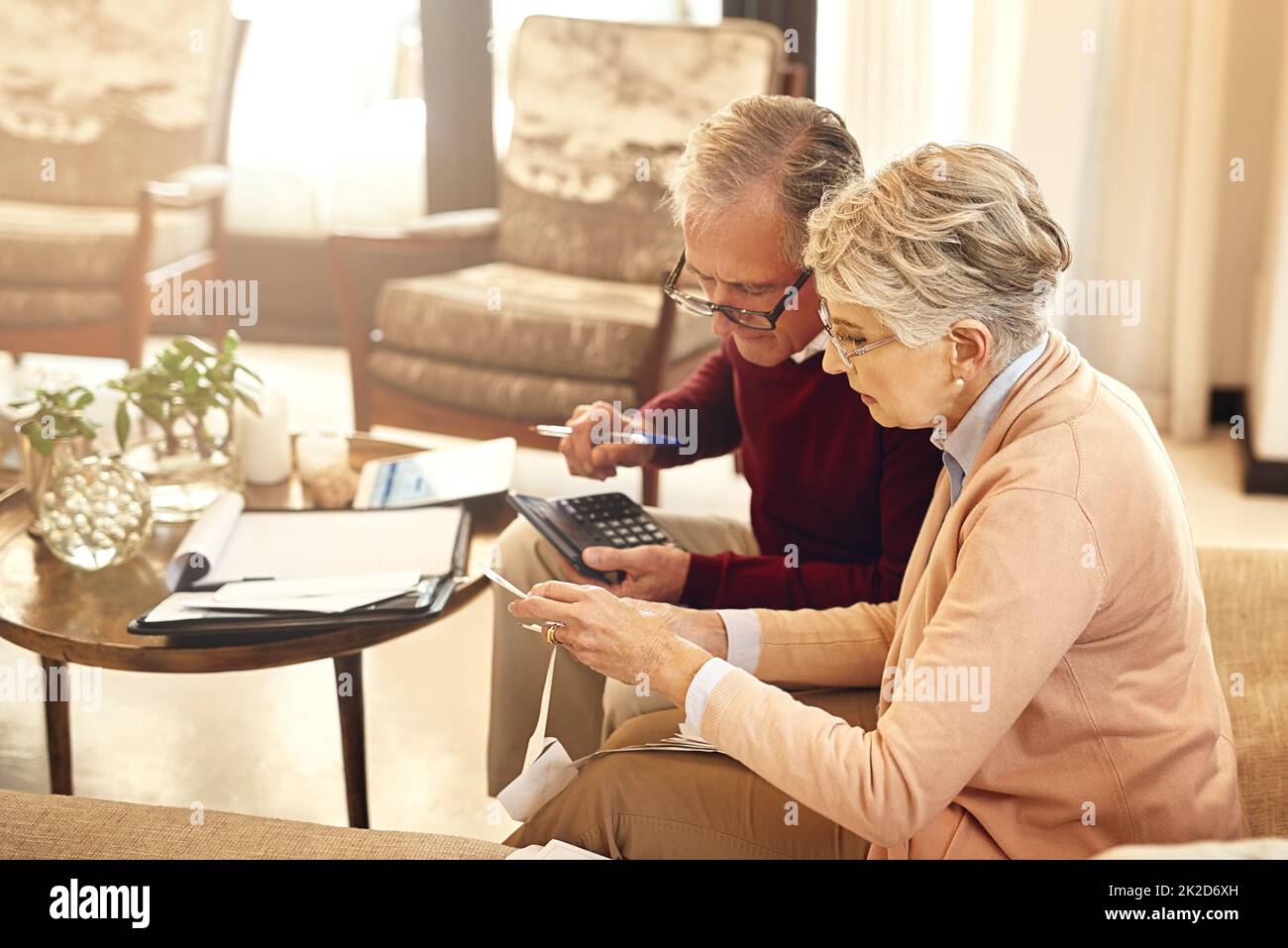 Making sure all our debts are in order. Shot of an elderly couple