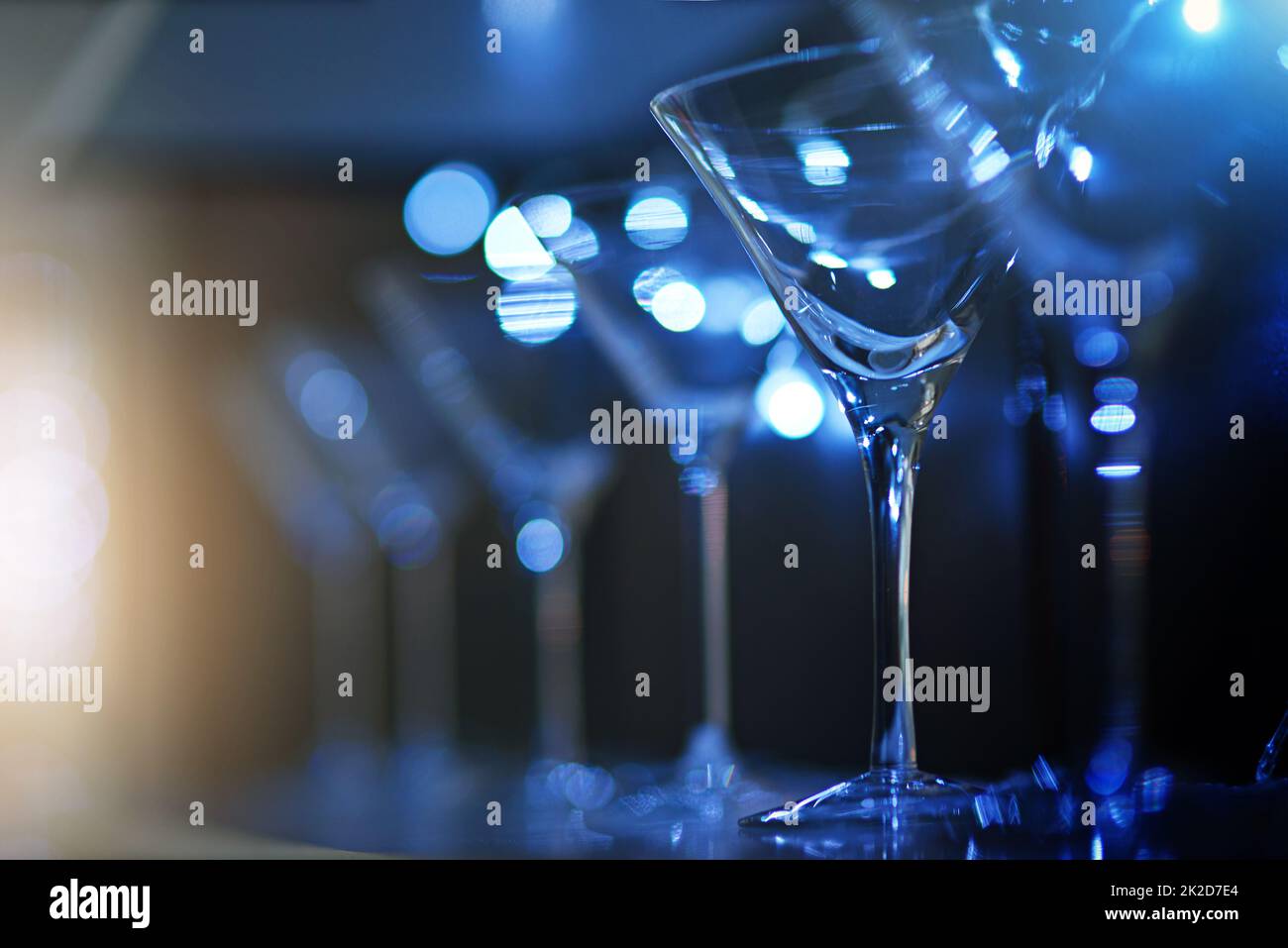 Whats your drink of choice. Shot of empty cocktail glasses on a countertop in a nightclub. Stock Photo