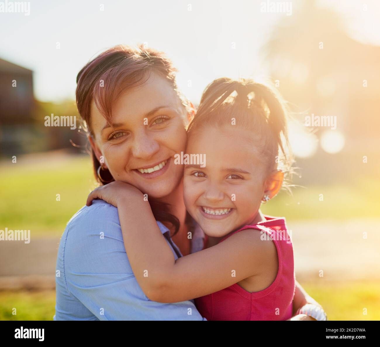 Quality time with mom. Portrait of a smiling mother hugging her little