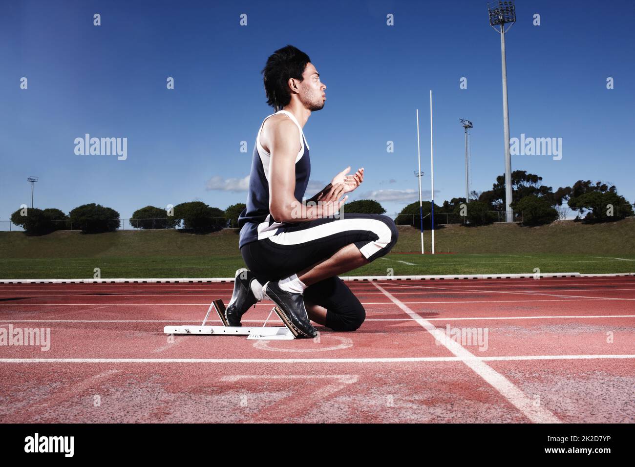 Clearing his mind before a race. A young athlete getting ready to start a race. Stock Photo