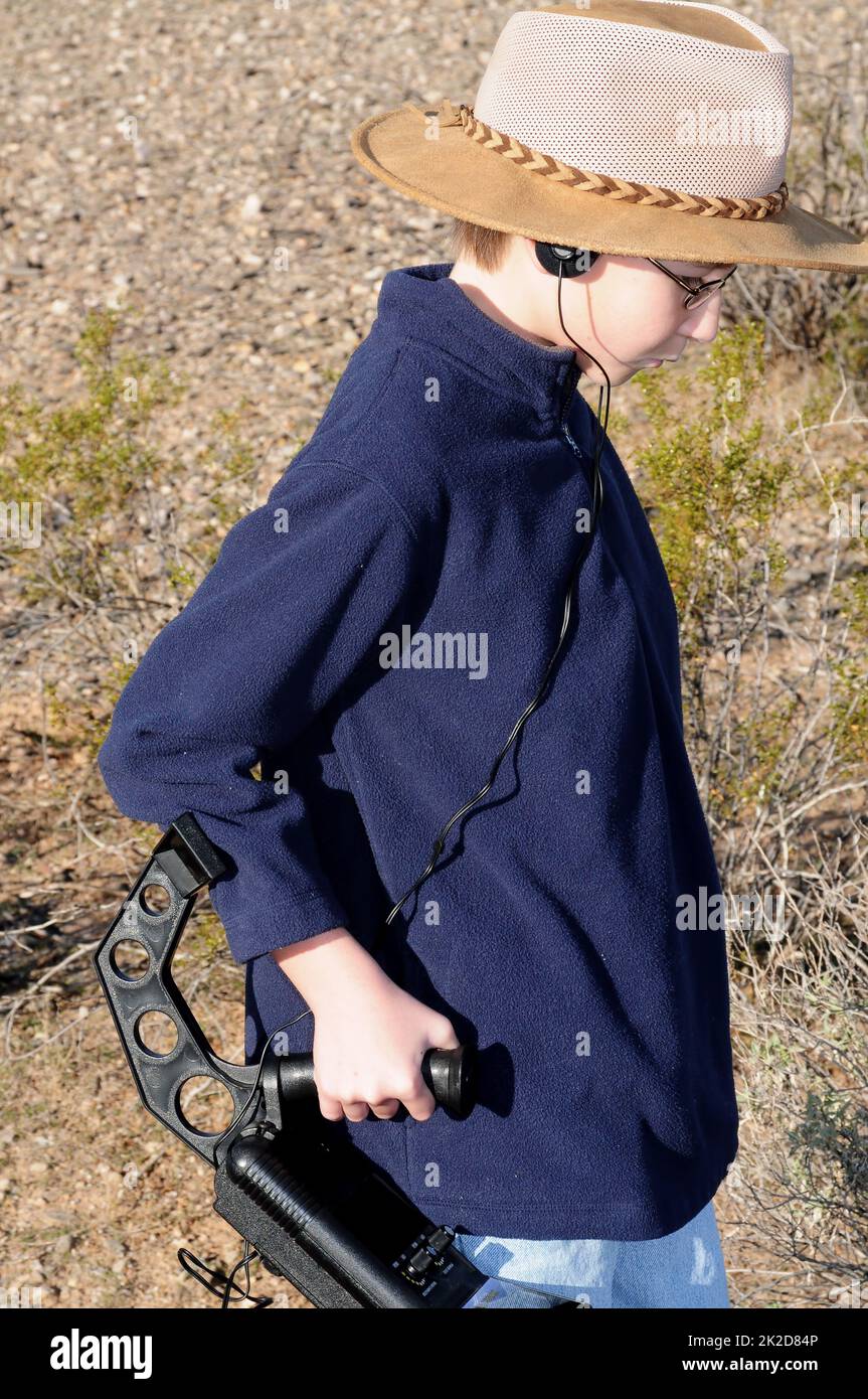 Boy with a metal detector treasure hunting Stock Photo
