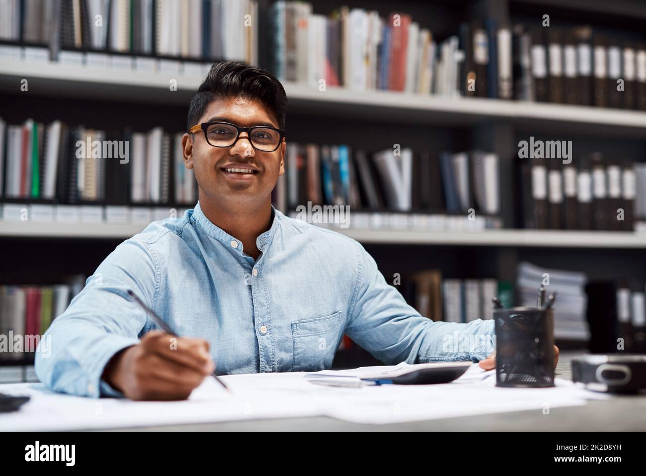 Your dream is my commitment. Shot of a young architect designing a building plan in a modern office. Stock Photo