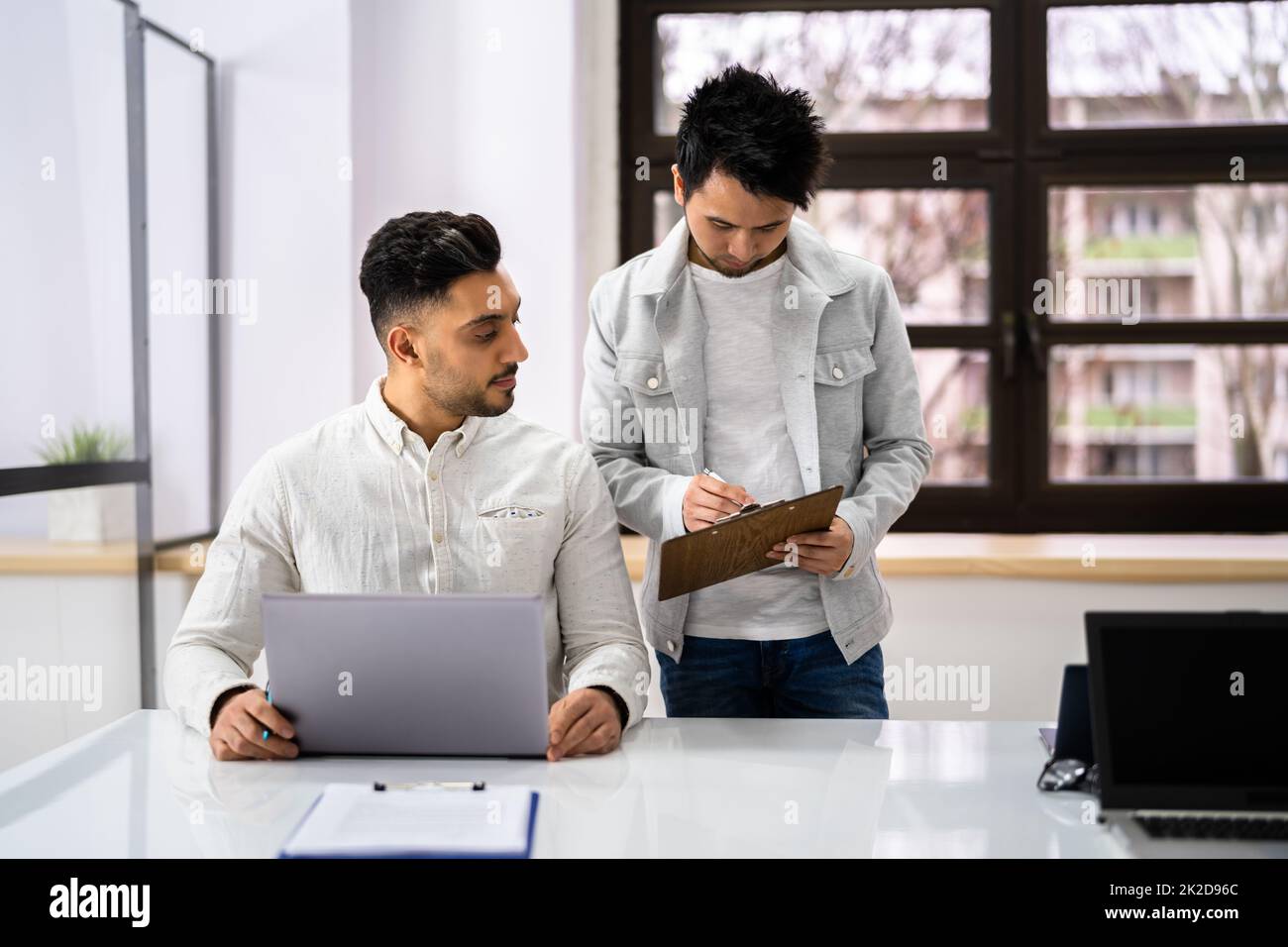Two Happy Young Businesspeople Working On Computer Stock Photo