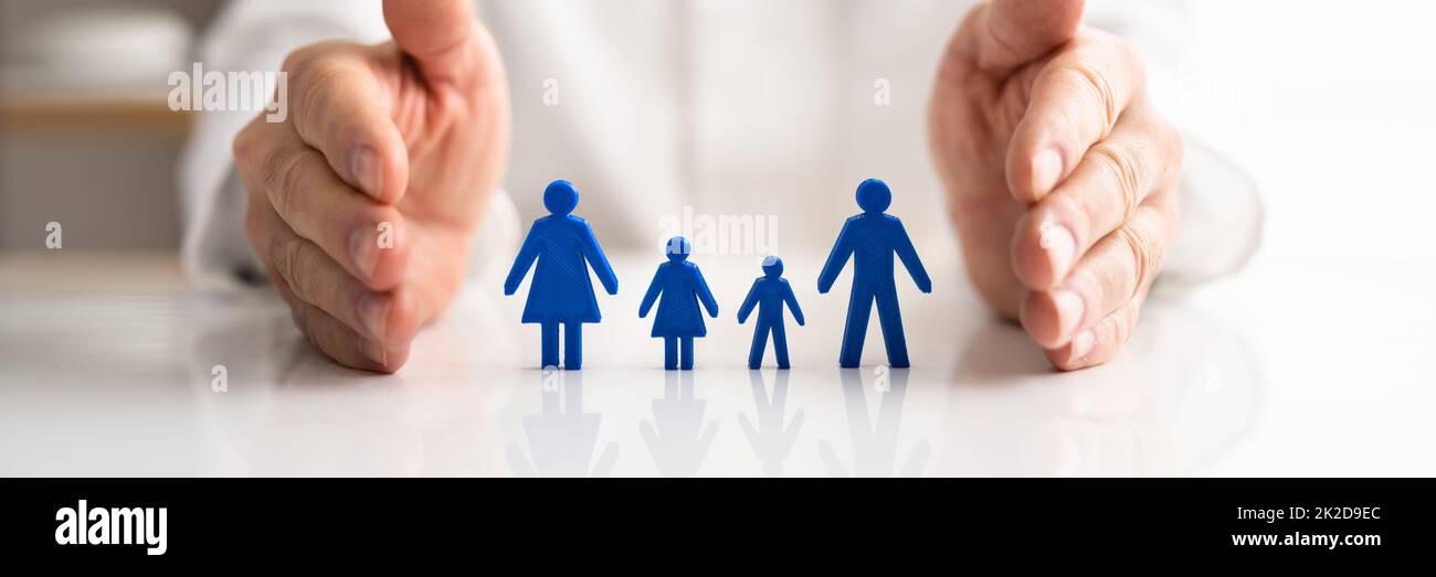 Doctor's Hand Protecting Pawn Family Stock Photo