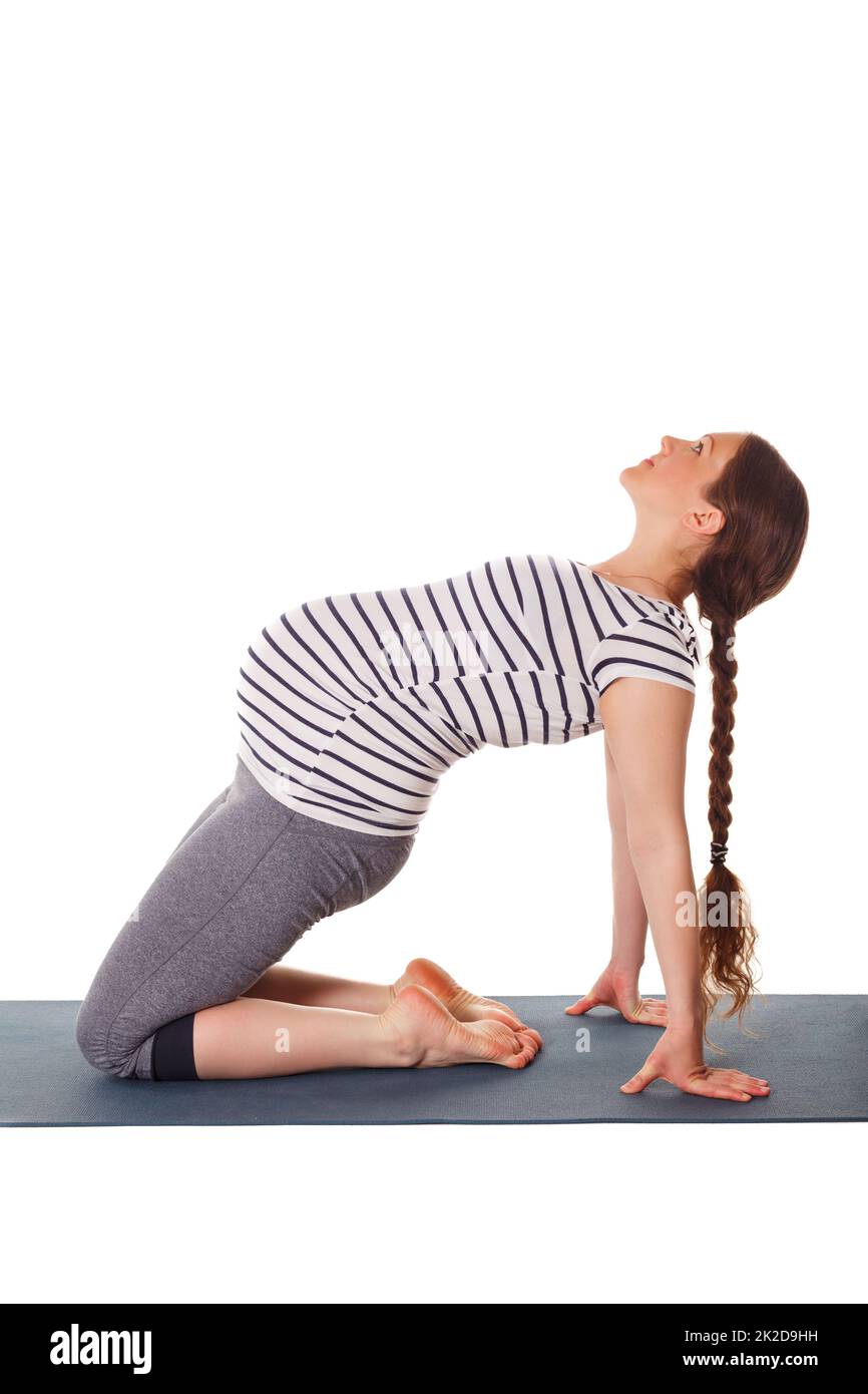 Pregnant woman doing yoga asana Ustrasana Stock Photo