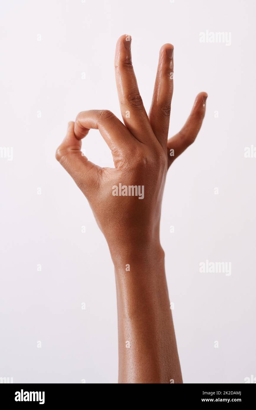 Im okay. Studio shot of an unrecognizable woman making an okay gesture against a white background. Stock Photo