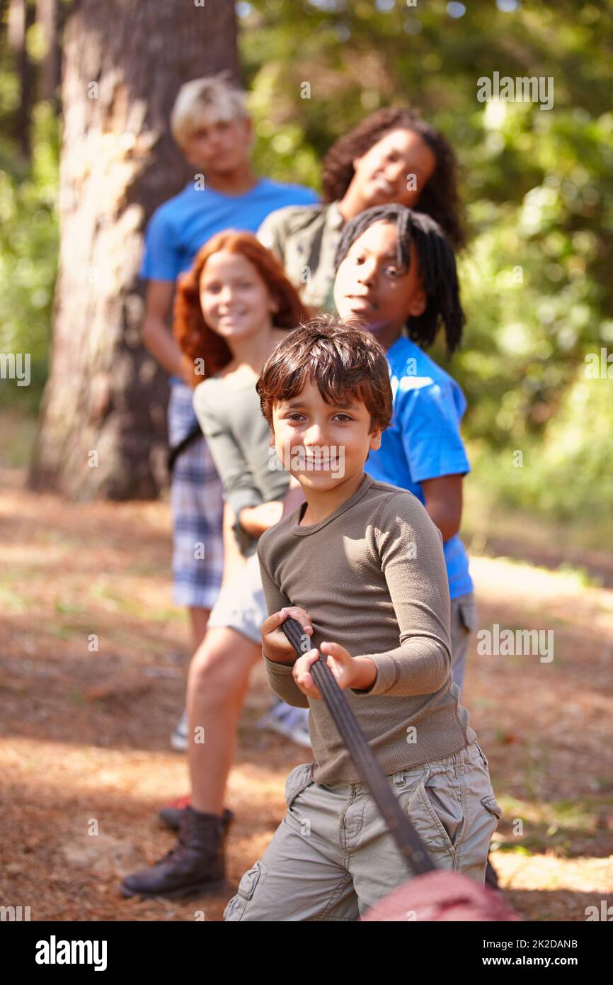 A group of kids in a tug-of-war game. Stock Photo
