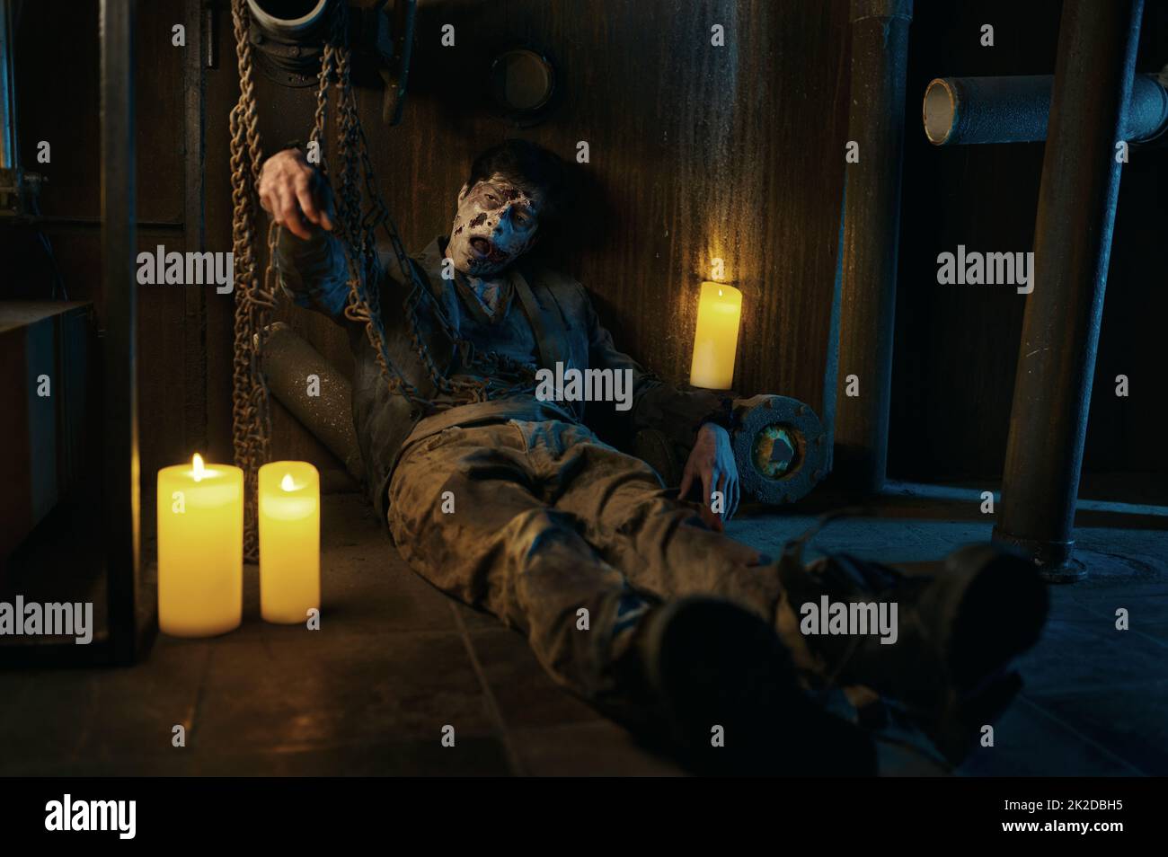 Chained zombie in basement of abandoned house Stock Photo
