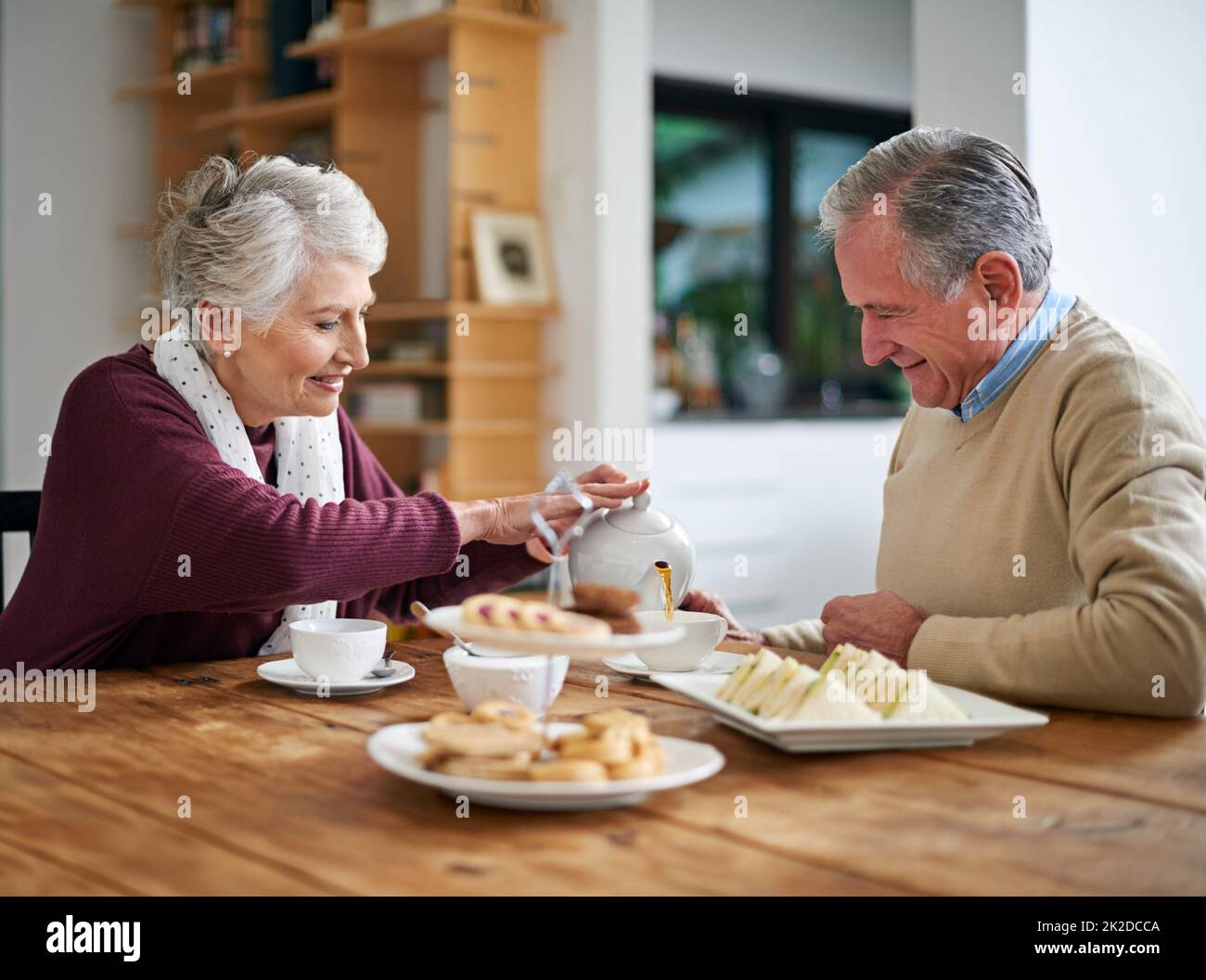 Youre my cup of tea, love. Cropped shot of a senior couple having lunch at home. Stock Photo