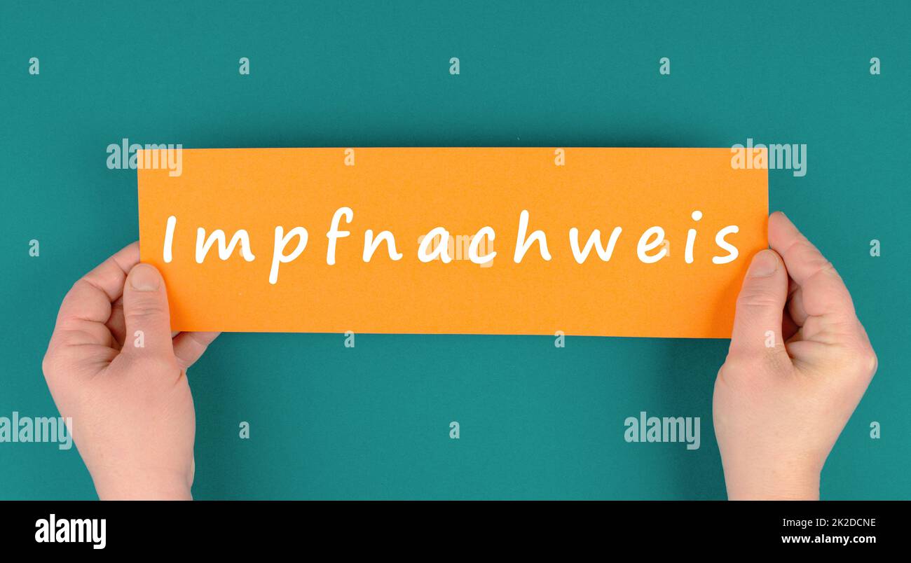 The word proof of vaccination is standing in german language on a paper