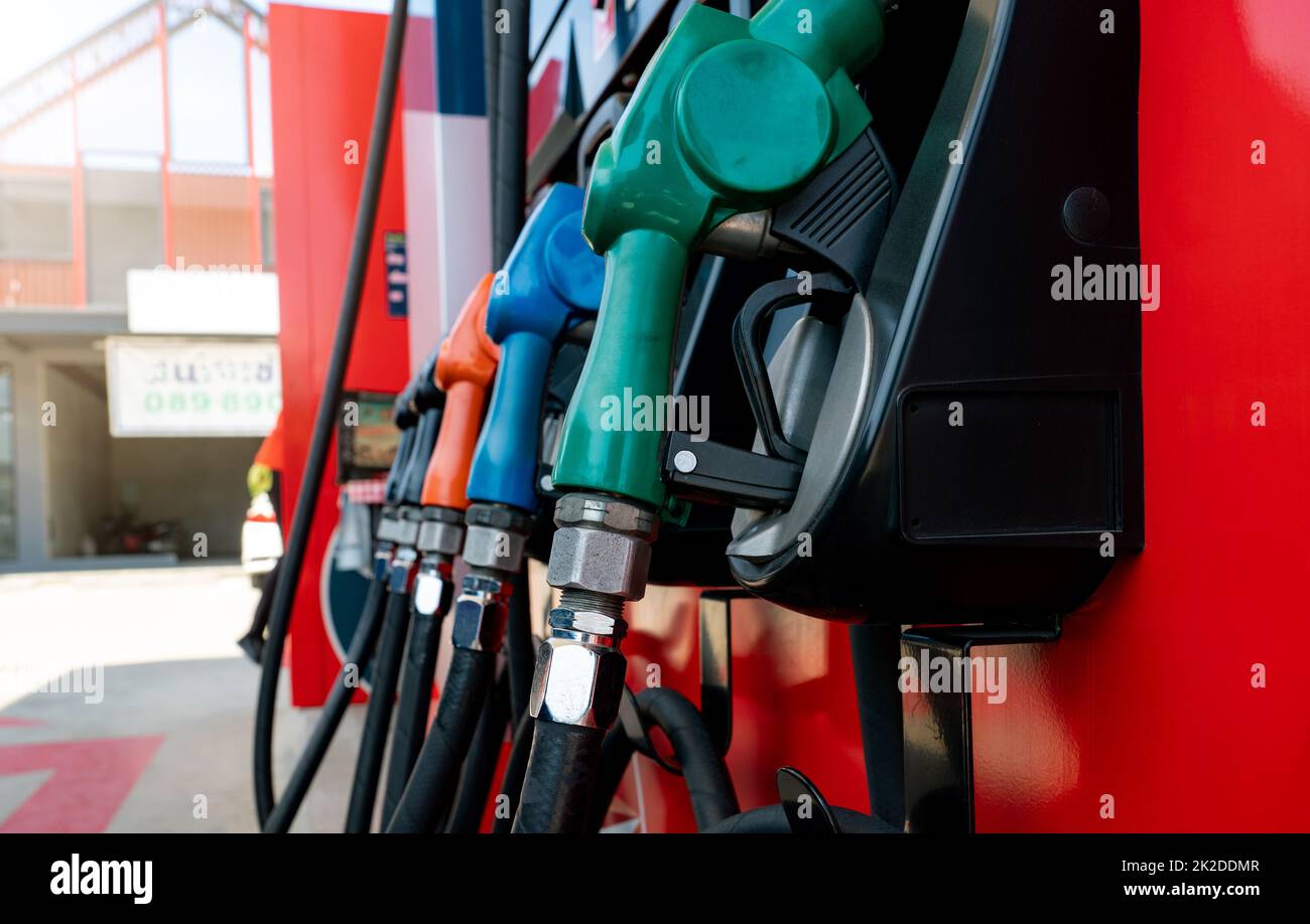 Petrol pump filling fuel nozzle in gas station. Fuel dispenser. Refuel fill up with petrol gasoline. Gas pump handle. Green petrol fuel nozzle. Petroleum oil industry. Oil crisis. Petrol price crisis. Stock Photo
